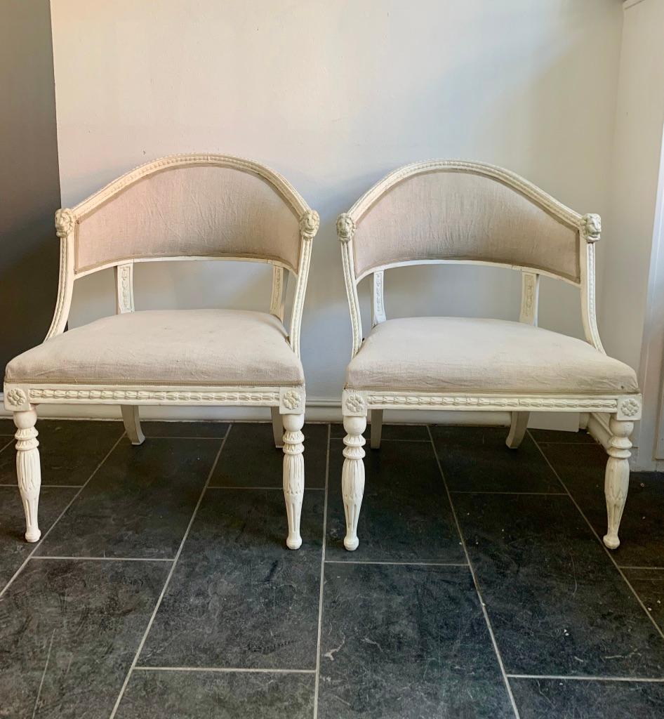 A pair of Swedish Gustavian Bucket Chairs. Made in Stockholm about 1800. Attributed to Ephraim Ståhl who was operative between 1794–1810.

Decorated with beautiful lion heads at the armrest and leaf shaped border.
The legs are elegantly