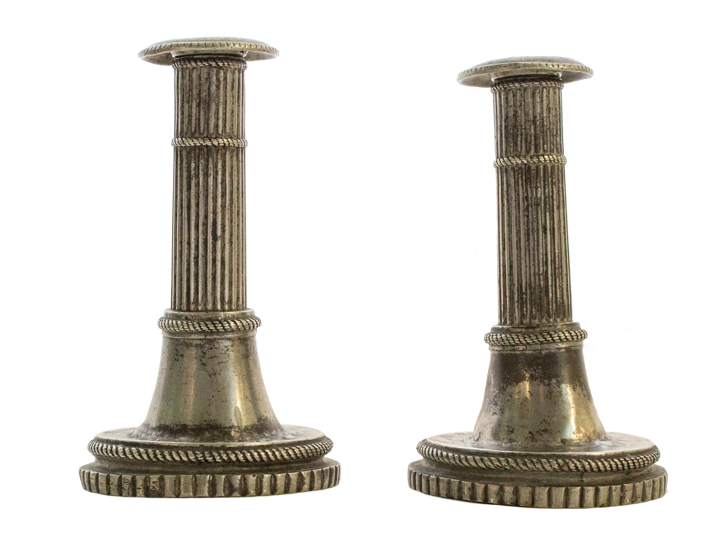 Swedish Gustavian candleholders. Made late 18th century in Pewter, signed N. Height ~ 16,5cm. Ribbed columns on a bell shaped postament, with loose light cuffs and charmingly patinated candlesticks. Fits perfectly in a cozy Bohemian 