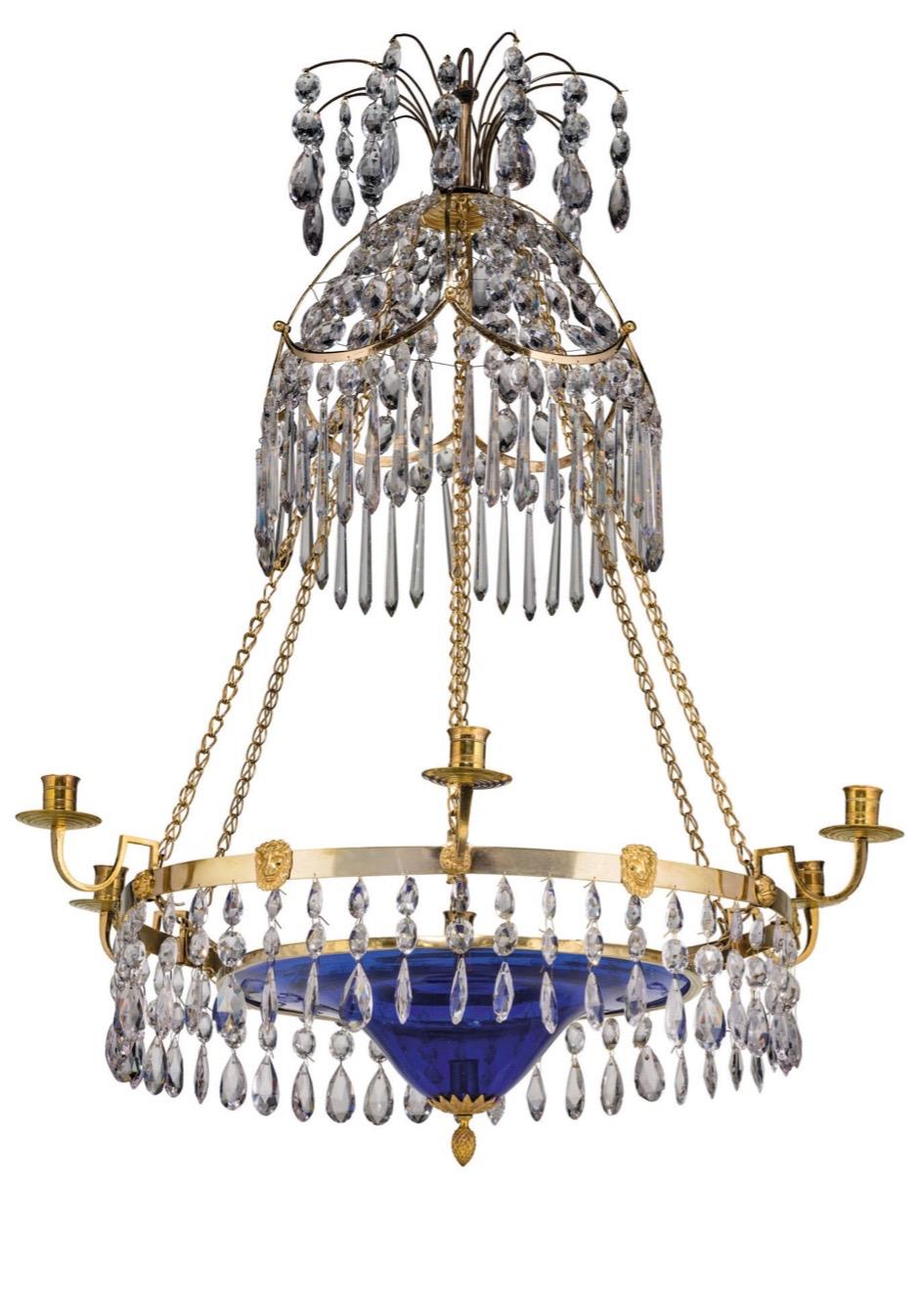 A finely designed Gustavian chandelier made for seven candles. It has six candle-arms around the ring and one candleholder in the middle of the blue bottom bowl. In Sweden we call this a poor mans candle.
The rings, chains etc are made of gilt