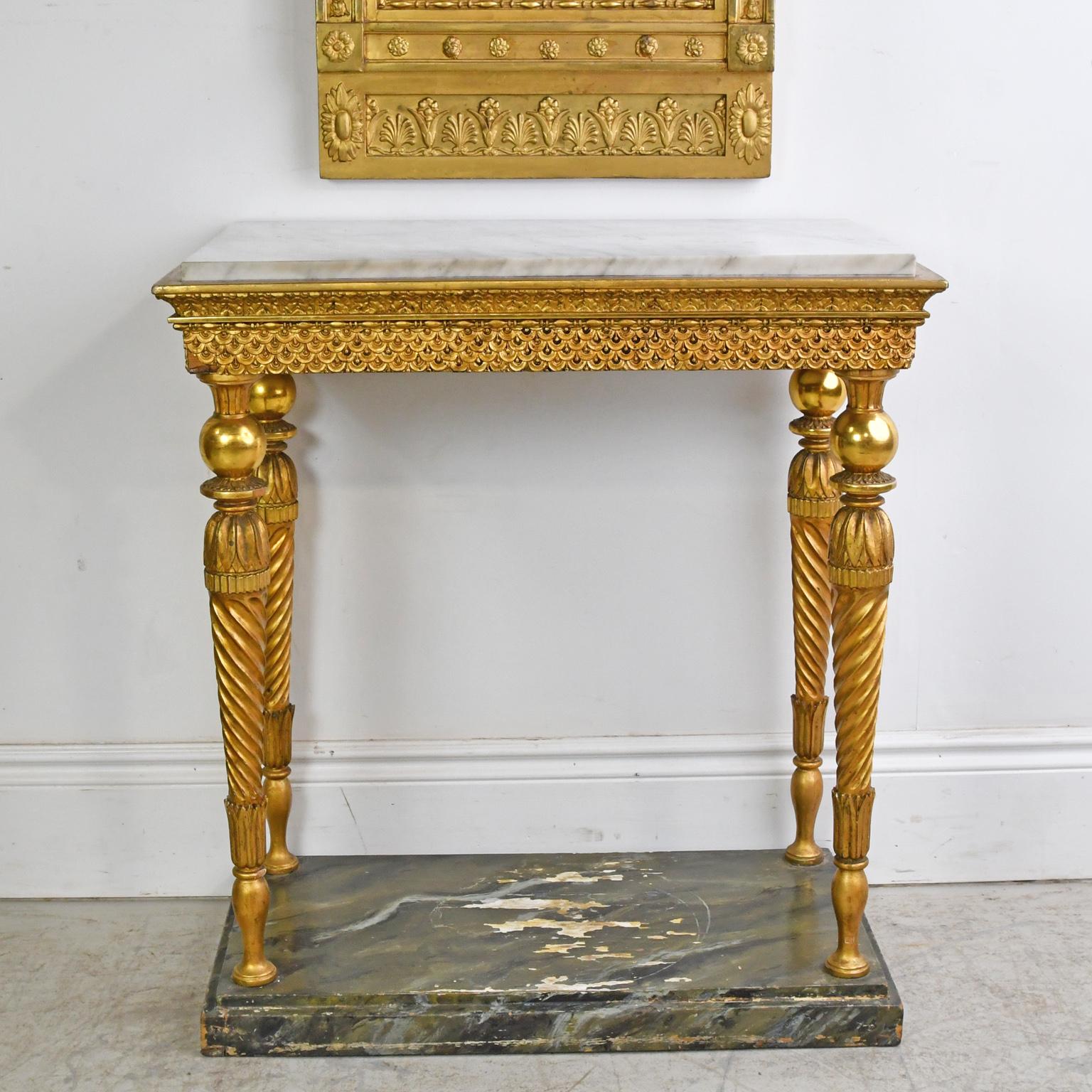 A very lovely console from the Swedish Gustavian period, a neoclassical style heavily influenced by the French Louis XVI style. In carved and gilded wood, the legs have carved water leafs and acanthus and are turned with a ball and discs that