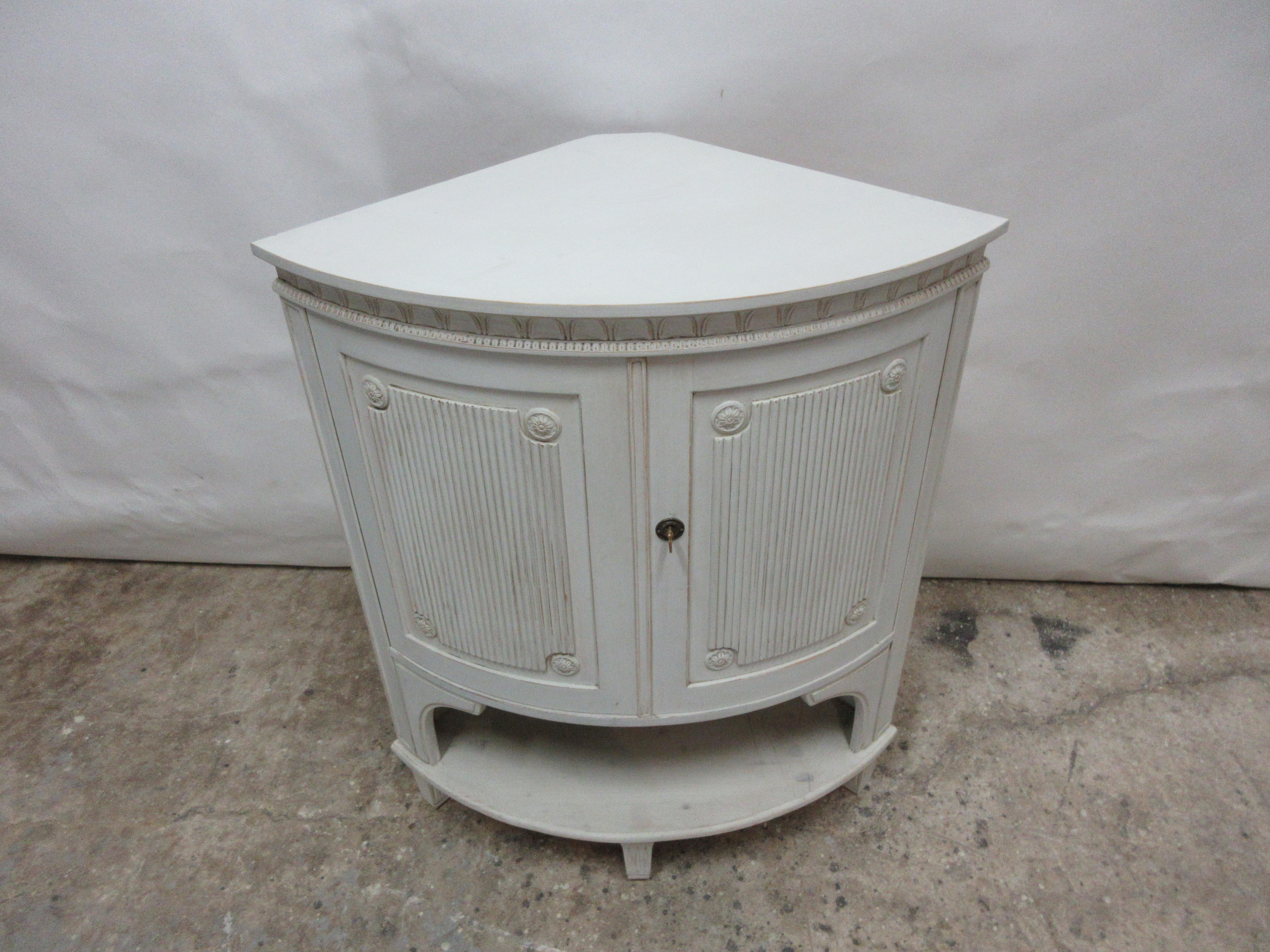 This is a Swedish Gustavian corner cabinet. it has been restored and repainted with milk paints 