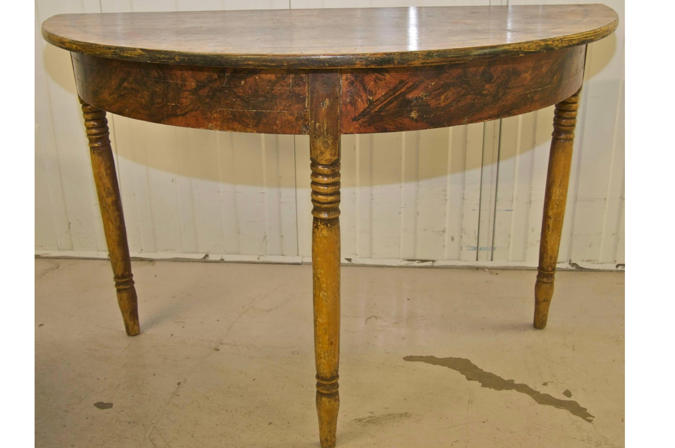 Rare pair of North Swedish Gustavian demilune tables hand decorated in delicious faux wood grain in the Classic Kurbits Folk Art tradition.

Lovely slender Gustavian style legs.

The tables have acquired a lovely patina of age and are structurally