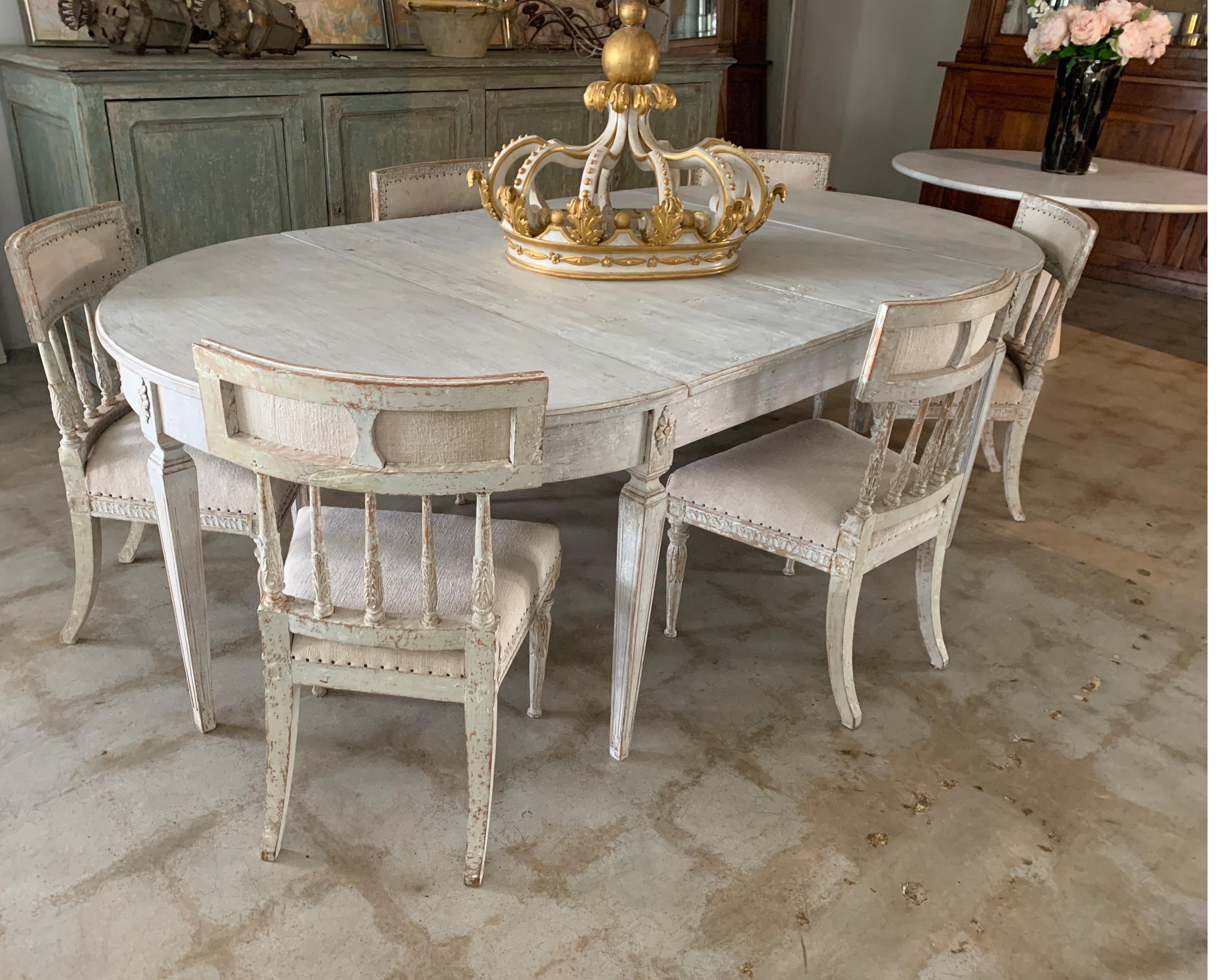 This is a beautifully painted pale gray Gustavian dining table with half table ends and two extension pieces. It is painted later than the original color and very modern and simple. The skirt height is 24 5/8 from the floor so lower seat is best for