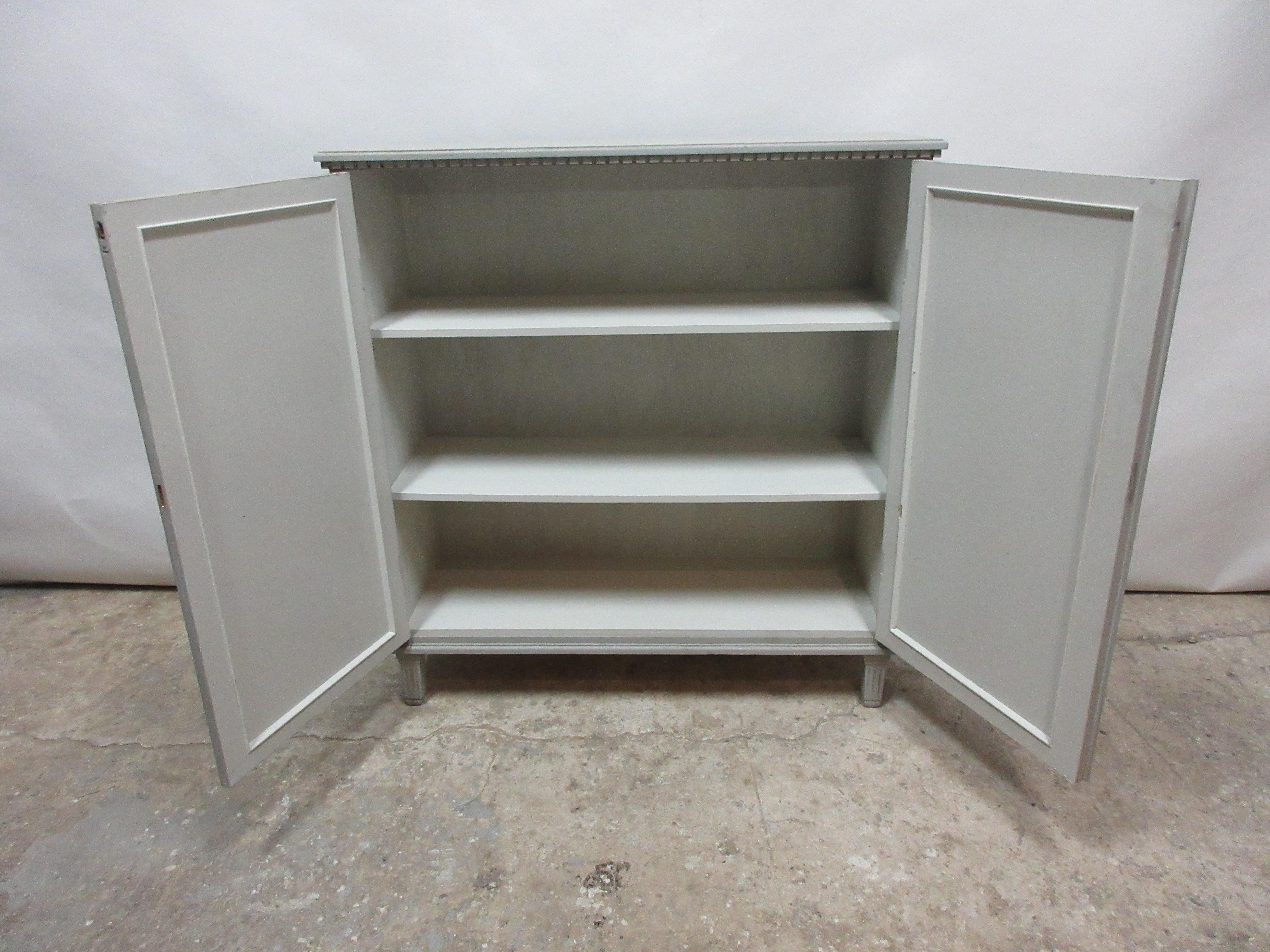 This is a 2-door Swedish Gustavian fluted door sideboard. This cabinet has been restored and repainted with milk paints 