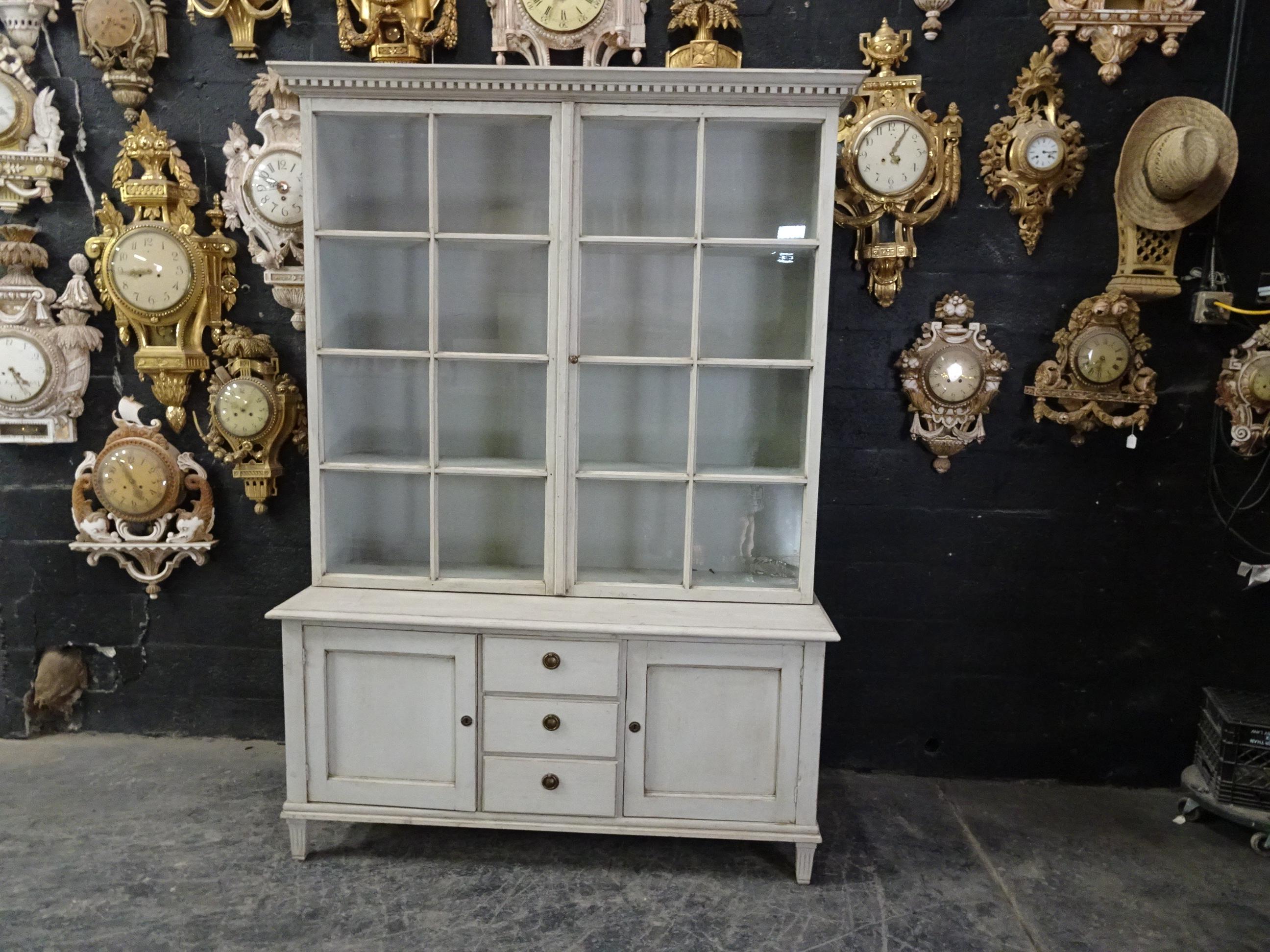 This is a Swedish Gustavian glass top cabinet. Its been restored and repainted with milk paints 