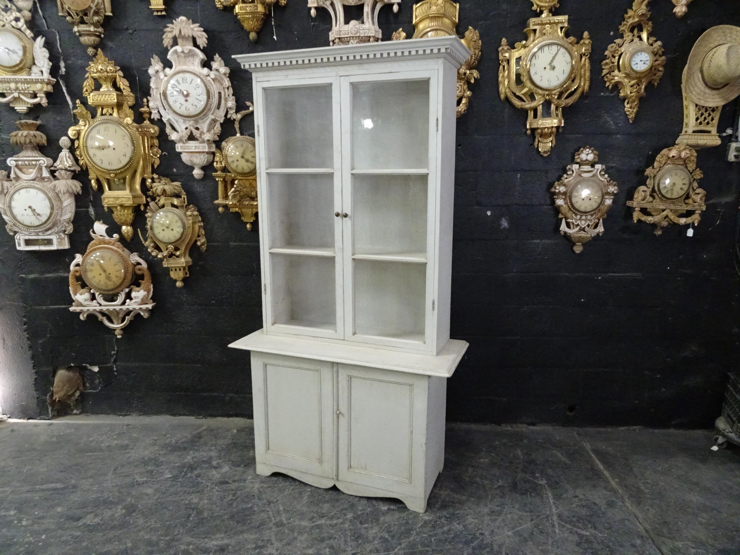 This is a Swedish Gustavian glass top hutch, its been restored and repainted with milk paints 