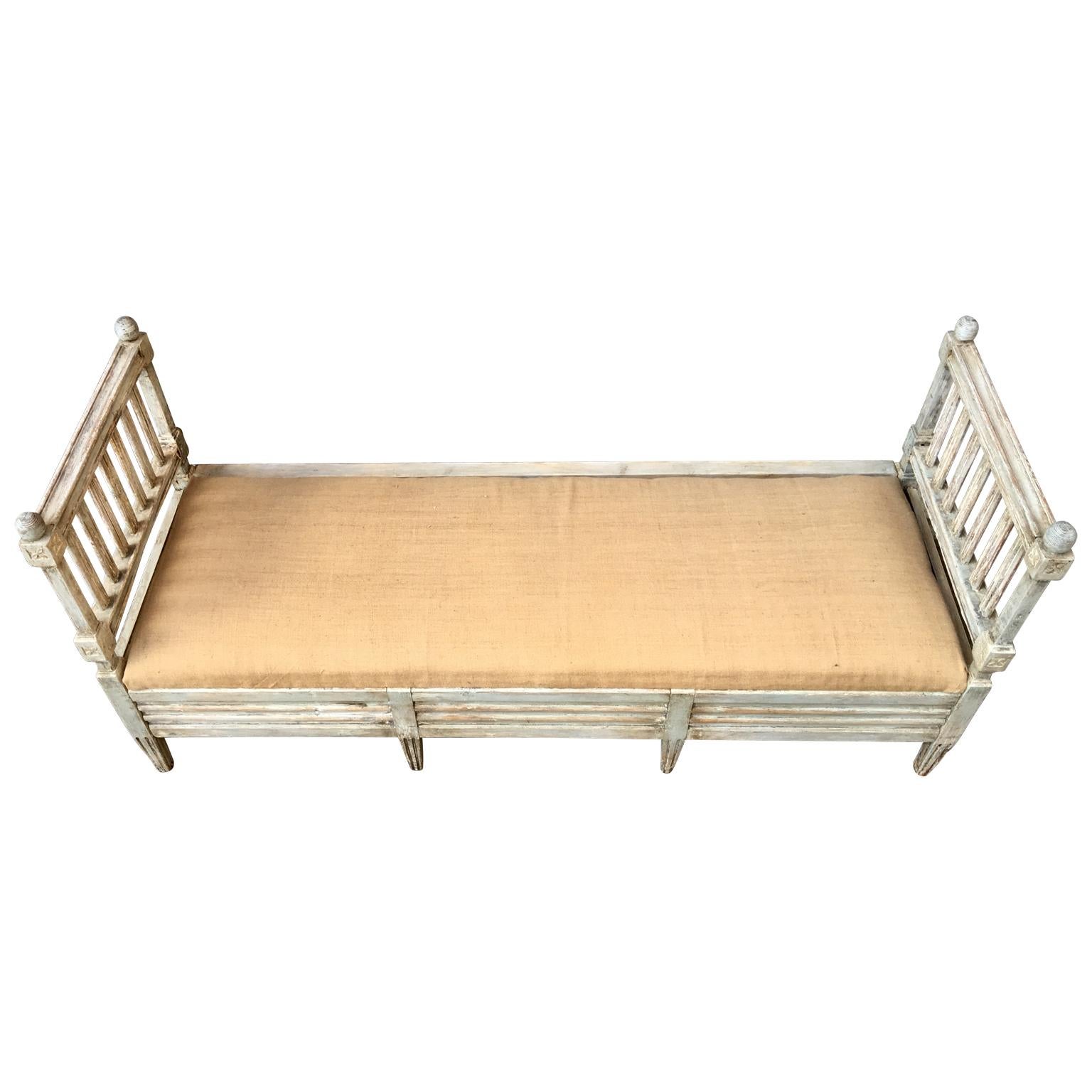 A Swedish Gustavian period grey painted bench, sofa. The sit can be removed and the place under it can be used for storage of linnen, blankets or similar. The Scandinavian rural culture is the mother of compact living.