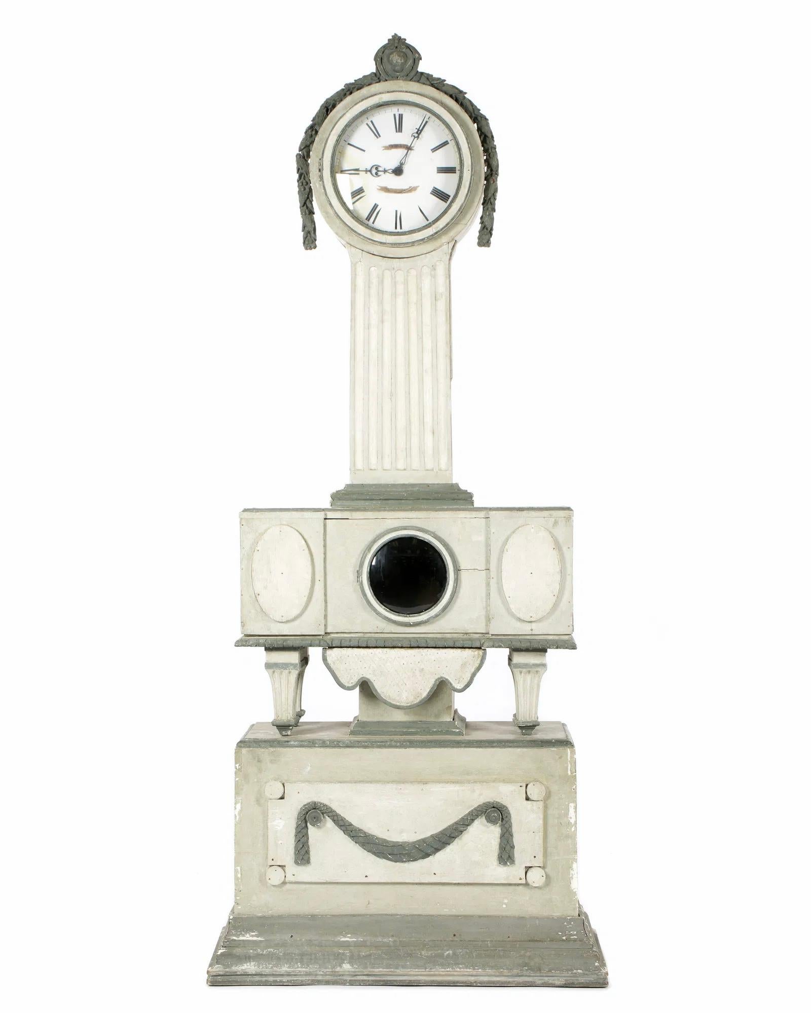 Incredibly rare Swedish Gustavian Neoclassical grey painted pine tall case clock, late 18th or early 19th century, having a circular hood surmounted by a cartouche, the face with Roman numerals and illegible maker's name, rising on a fluted trunk