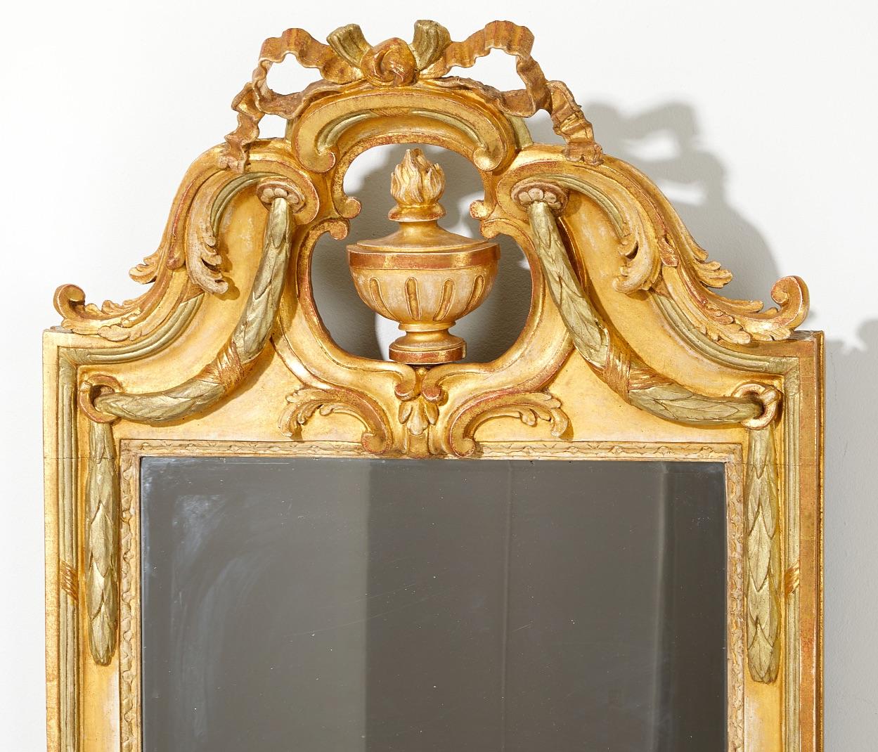 An important Swedish giltwood gustavian mirror by Johan Åkerblad, master in Stockholm 1758-1799. Ca. 1775. Signed IÅ. The gold leaf guilding in 