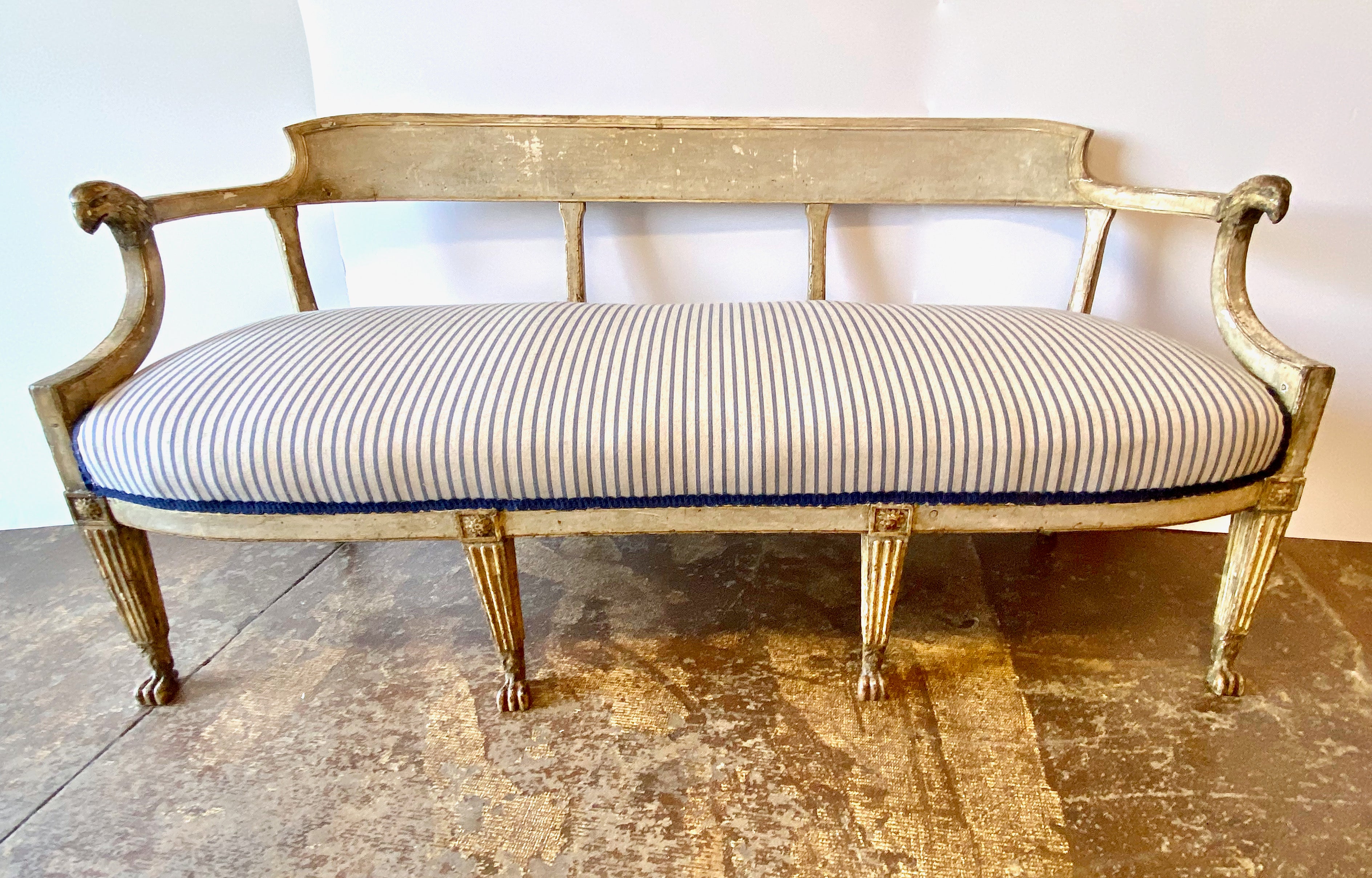 This is a beautifully elaborated c. 1800 Swedish Gustavian bench or settee. The bench retains its original painted surface which has acquired a superb natural patina over its 200 years of life. The bench features a curved shaped wooden back which