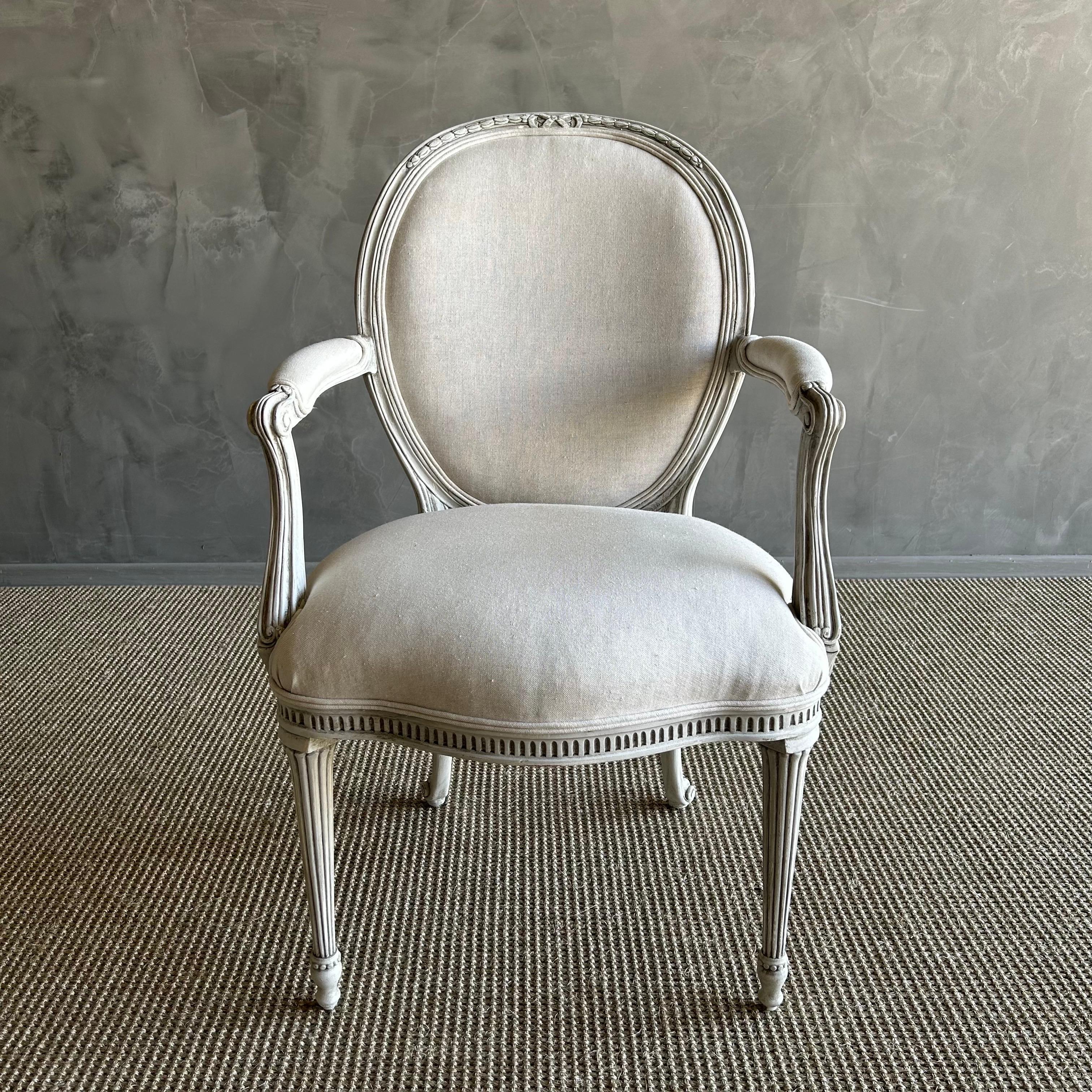 20th century Gustavian style chair crafted from solid fruitwood and painted in a charming oyster white finish. This chair is not only visually stunning but also robust and dependable, perfect for daily use. Whether you are looking for an elegant