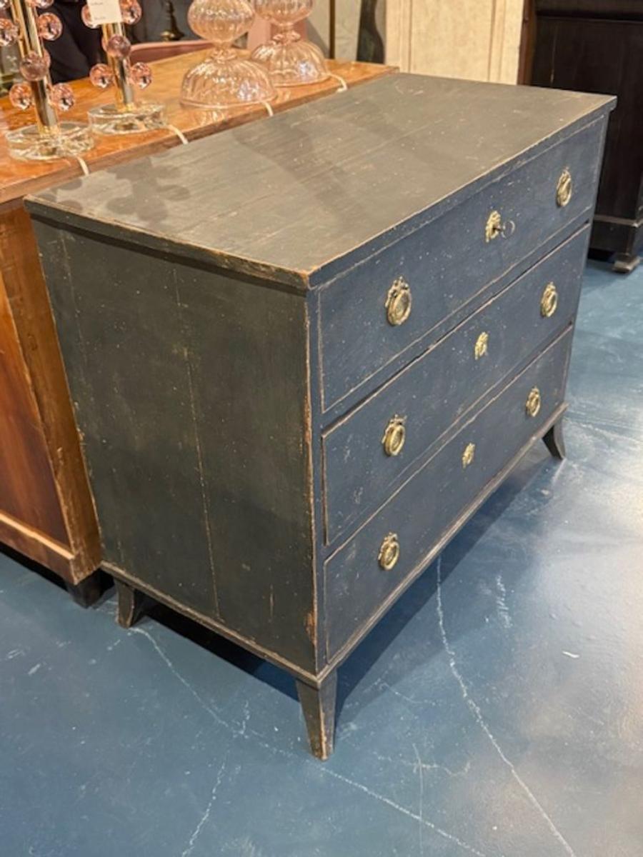 Late 19th century Swedish Gustavian distressed painted navy chest with brass hardware. These chests are perfect for adding a touch of antique serenity to bedrooms, foyers, or even modern interiors that need a whisper of history. Circa 1900. 49W x
