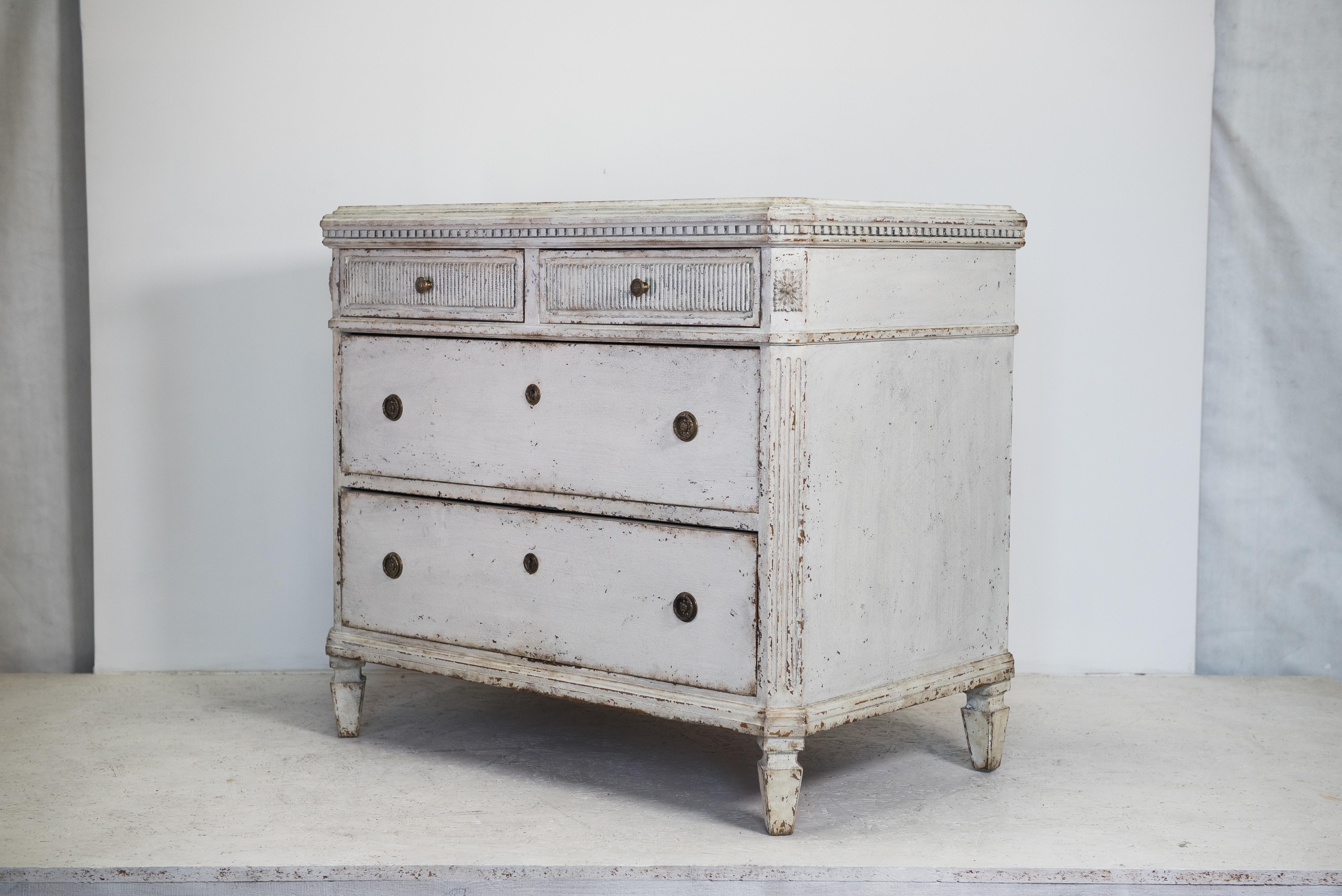 Please note - this item will be available to ship form early march 2022

C 1850 antique Swedish Gustavian painted chest of 4 drawers commode with detailed decorative motifs on the top rail, front and brass detailing.

It has 4 drawers with brass
