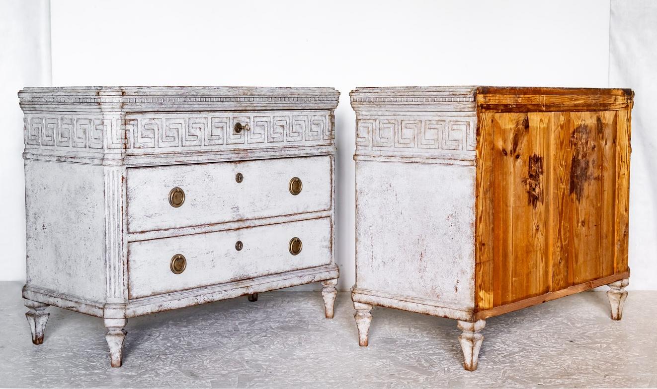 

Circa 1850 antique Swedish Gustavian Grey White painted chest of drawers commode in gustavian style with classic Gustavian carved detail on the drawer fronts and leading edges. 

They  have pyramid feet, carved top edge and 3 drawers.  The top