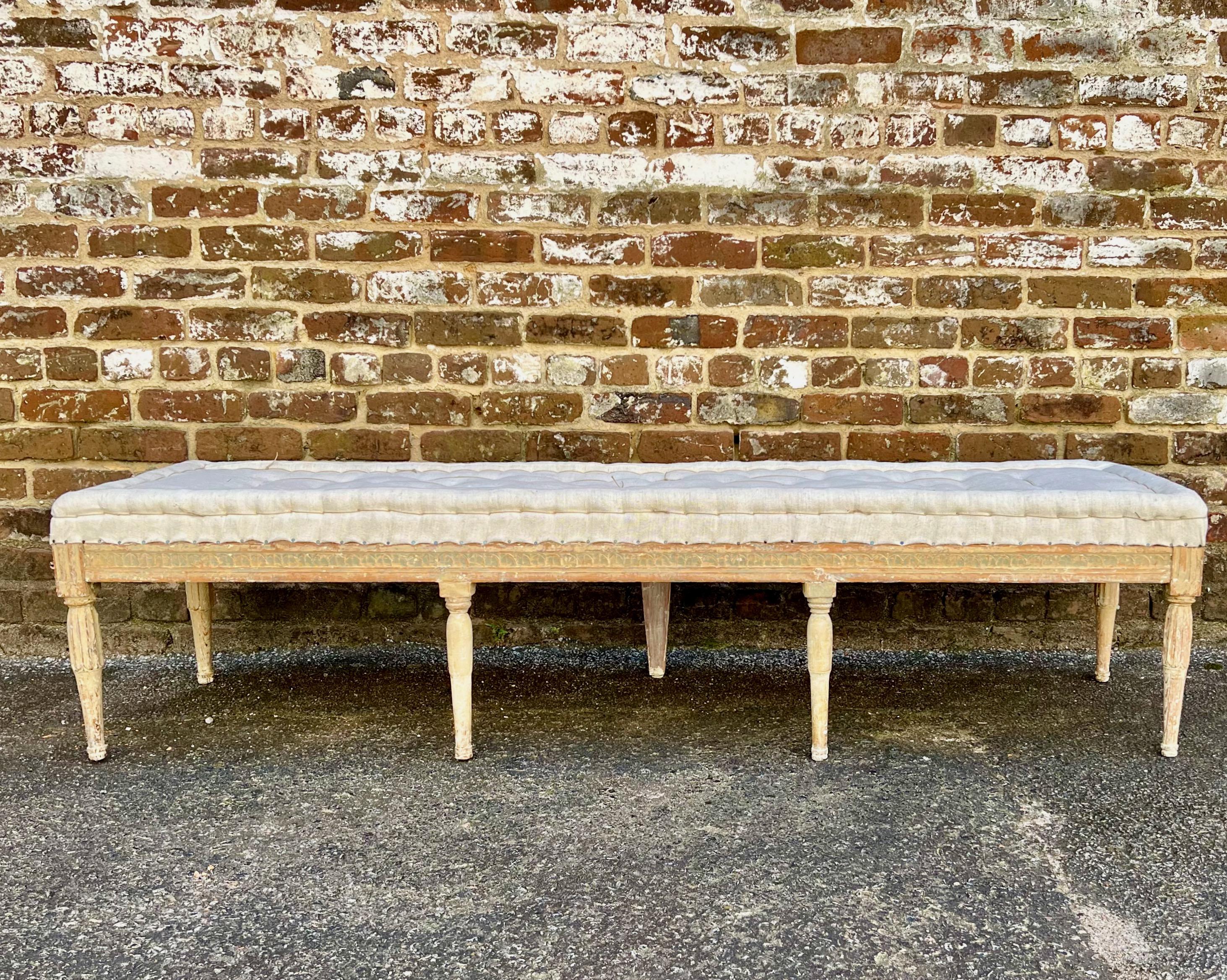 Very rare. Swedish Gustavian period bench, circa 1800, finished on all three  sides with Guilloché carvings on carved round fluted legs. Scraped to original cream /white finish and upholstered in traditional way in antique handstitched linen.