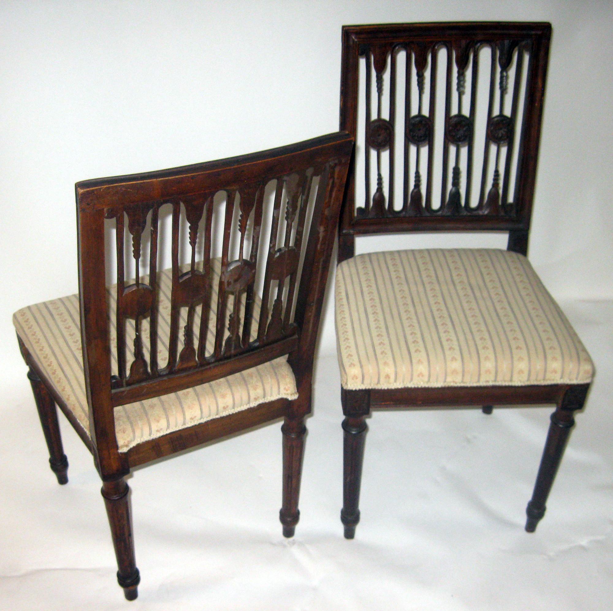 Set of two Swedish chairs with classical lotus pattern back splats, a design often attributed to the chair makers of the Stockholm Guild. The chair splats have the carved crest also typical of the Gustavian period. All four legs are carved and