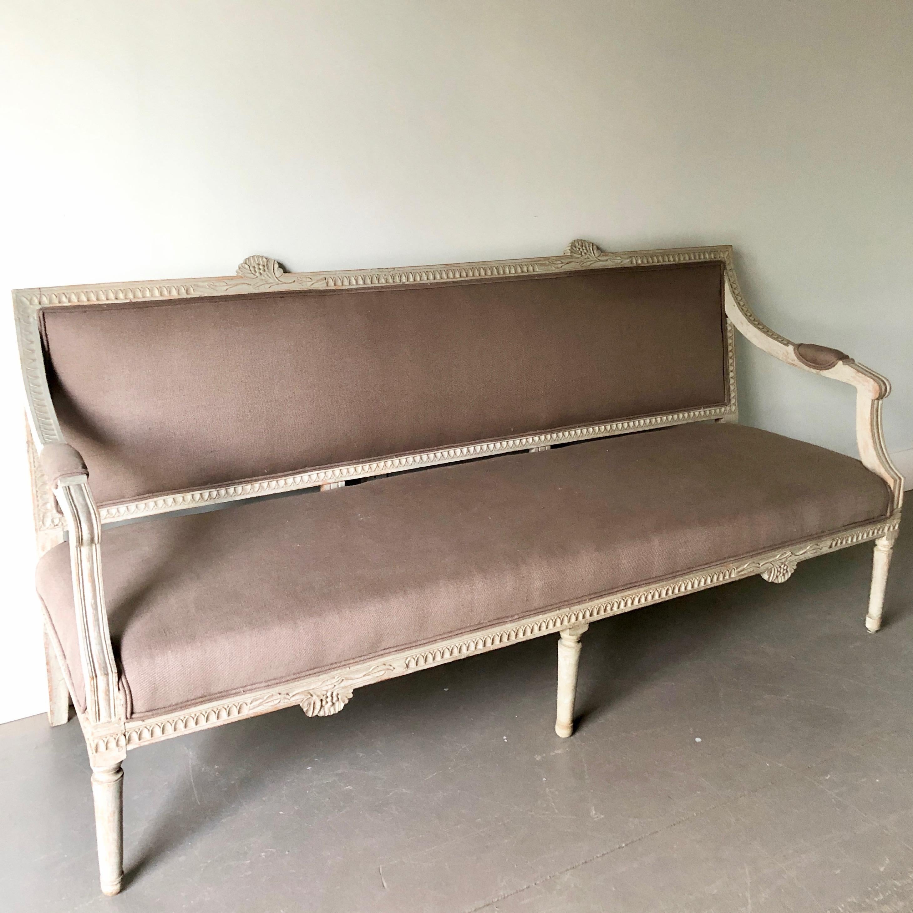 Painted Gustavian period settee, having the signature fruit and flower carvings of the hops plant used by Lindome furniture makers. Hand scraped to the original color and upholstered in gray linen.
Sweden, circa 1800.
