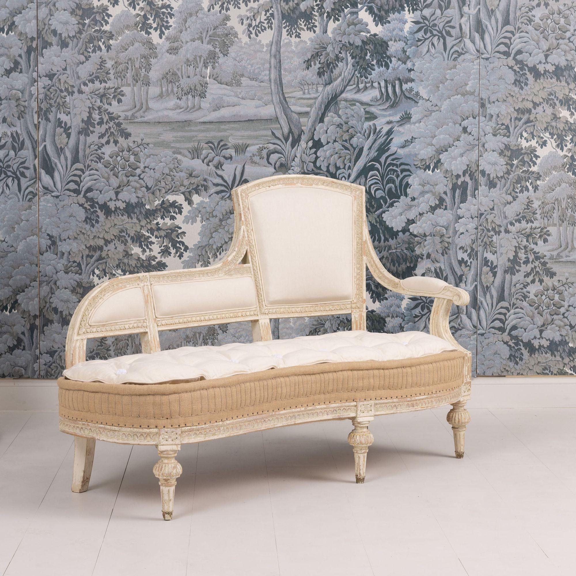 A rare Swedish chaise from the Gustavian period with beautifully shaped seat in original paint. Egg and dart carved detail around the frame, rosettes on the leg posts with fluted round end caps. Newly upholstered in linen with a burlap hand-stitched