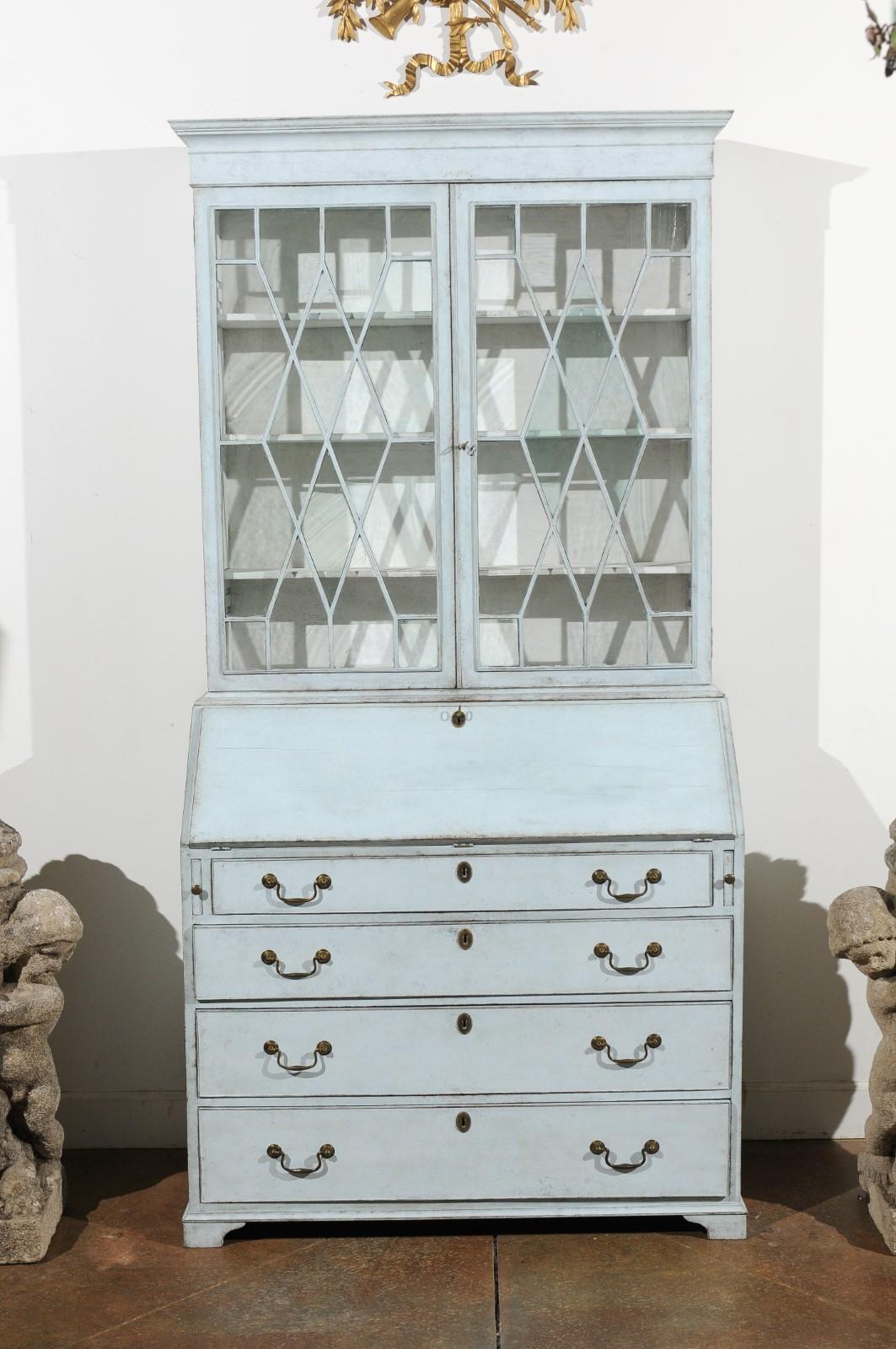 A Swedish Gustavian period two-part painted secretary from the late 18th century, with glass doors and slant-front desk. Born in Sweden in the last decade of the 18th century, this tall painted secretary features a molded cavetto cornice,