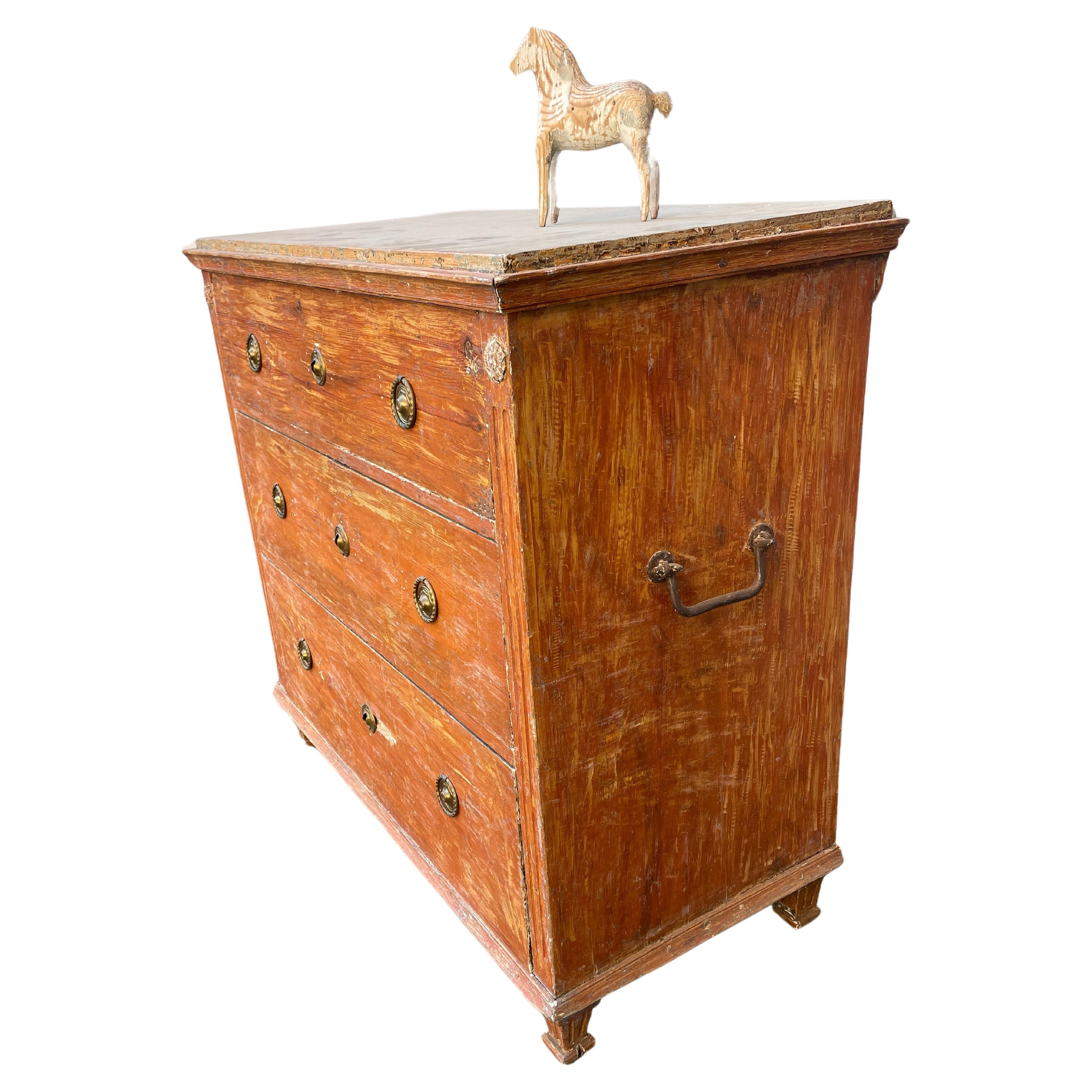 Painted Chest of Drawers with Faux Marble Painted Top

Hand carved, hand painted and hand distressed in a muted Scandinavian red toned color. The clean lines and elegance of this 3 drawer chest with period iron handles is equally at home in the