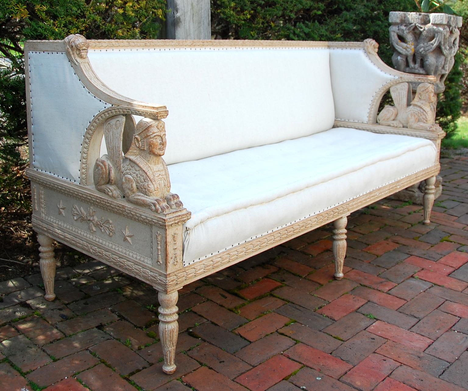 Swedish Gustavian style mid-19th century carved beechwood sofa. This rarity has full bodied hand carved sphinx arms. The whole frame is deeply carved with lion heads to accent the leaf-carved top rail, and extensive carving on most beech surfaces.