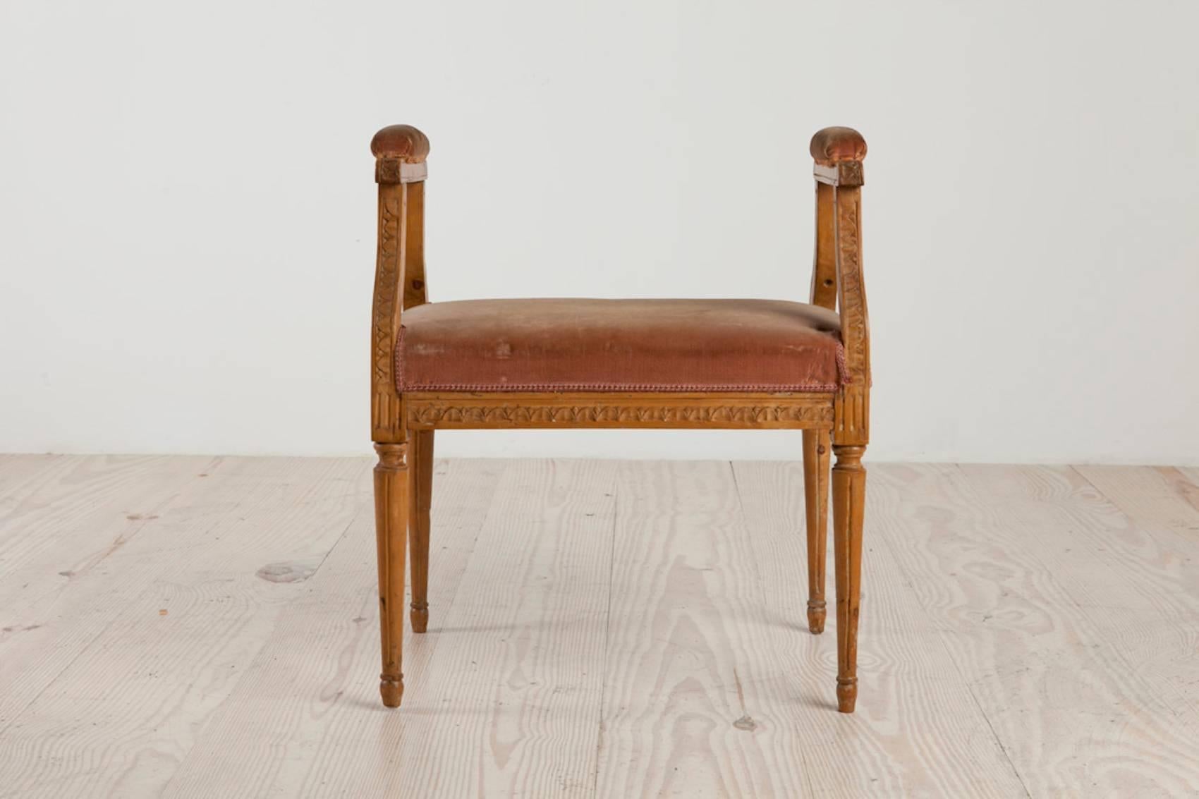 Swedish Gustavian stool with early velvet, circa 1780, Origin: Sweden, with carved overlapping leaves, and revised open arms, the seat and arms upholstered in antique velvet.
