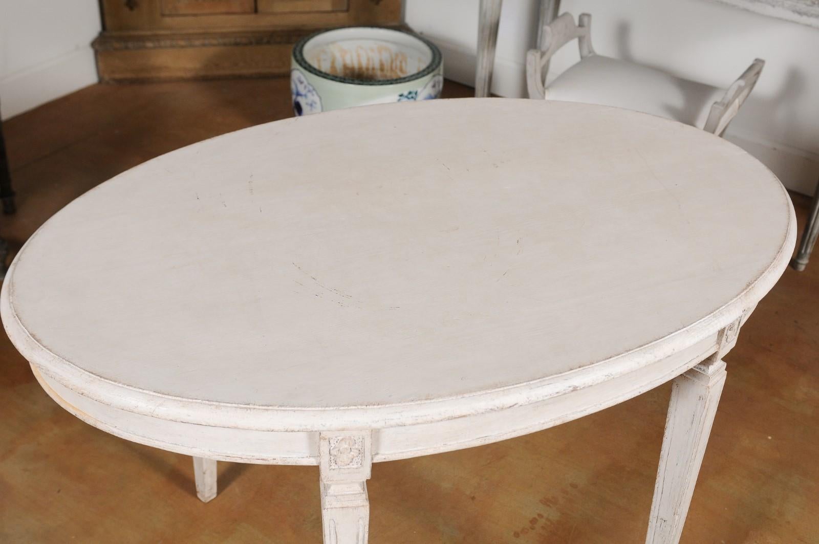 Carved Swedish Gustavian Style 1880s Oval Top Painted Table with Tapered Fluted Legs