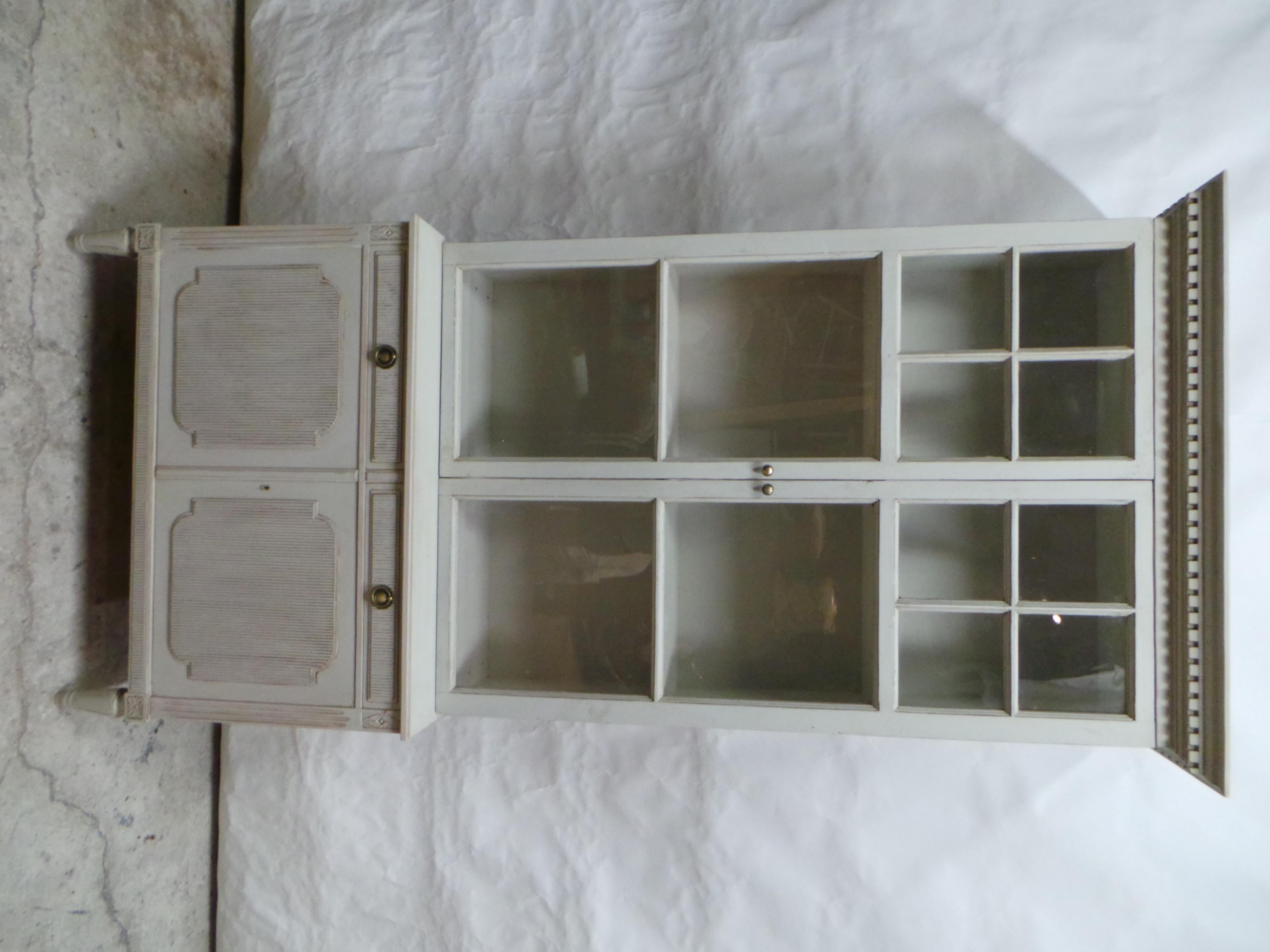 This is a Swedish Gustavian Style Glass Top Hutch. the bottom cabinet is circa 1950 the upper glass top is New made using Antique windows found at an Estate Auction in Sweden. the glass in the windows are full of bubbles and wavy glass. This cabinet