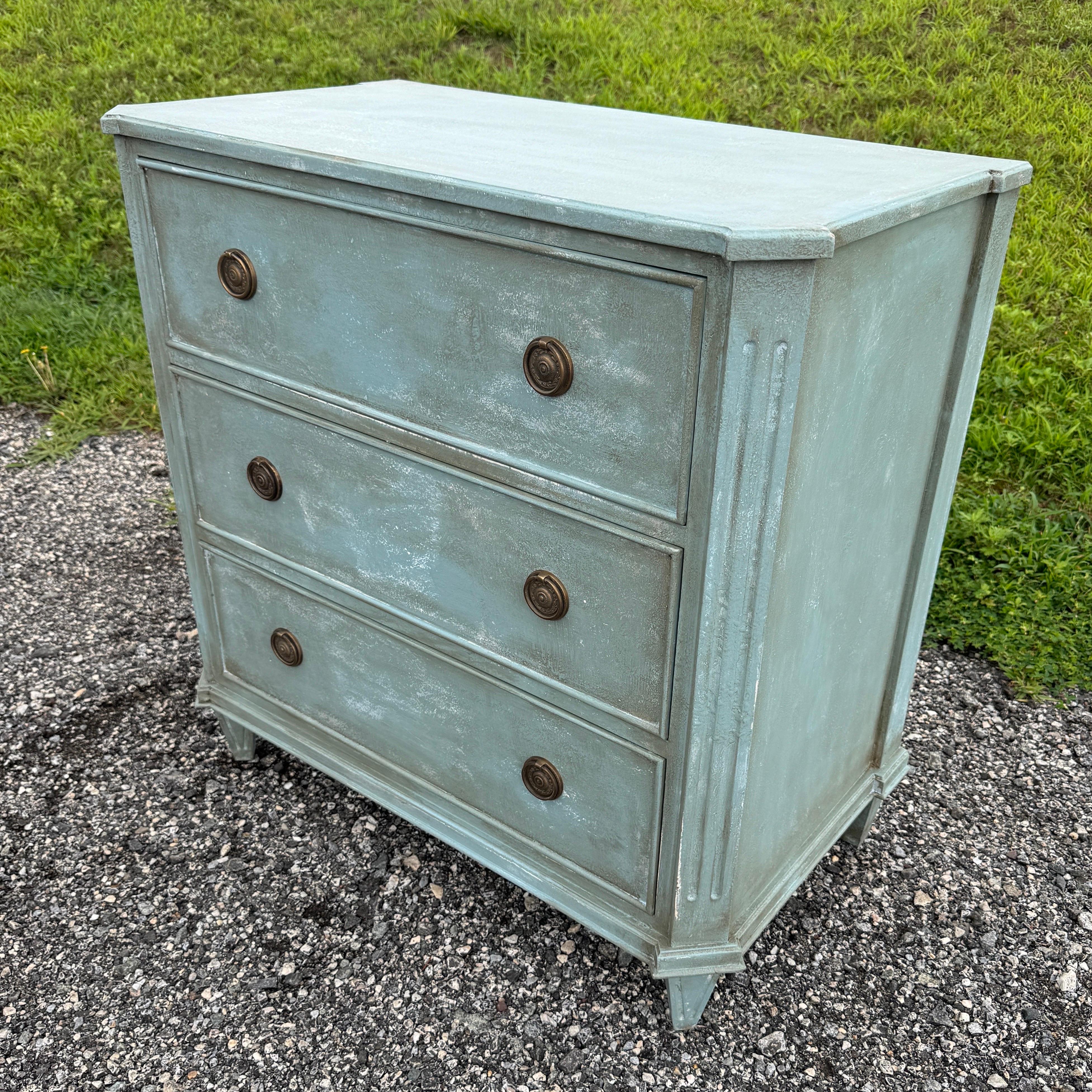 Petroleum Blue Painted Gustavian Style Chest of Drawers

This classic Swedish style three drawer hand-painted chest has been constructed from solid wood with a hand-applied distressed finish and features brass ring hardware. The chest, based on a