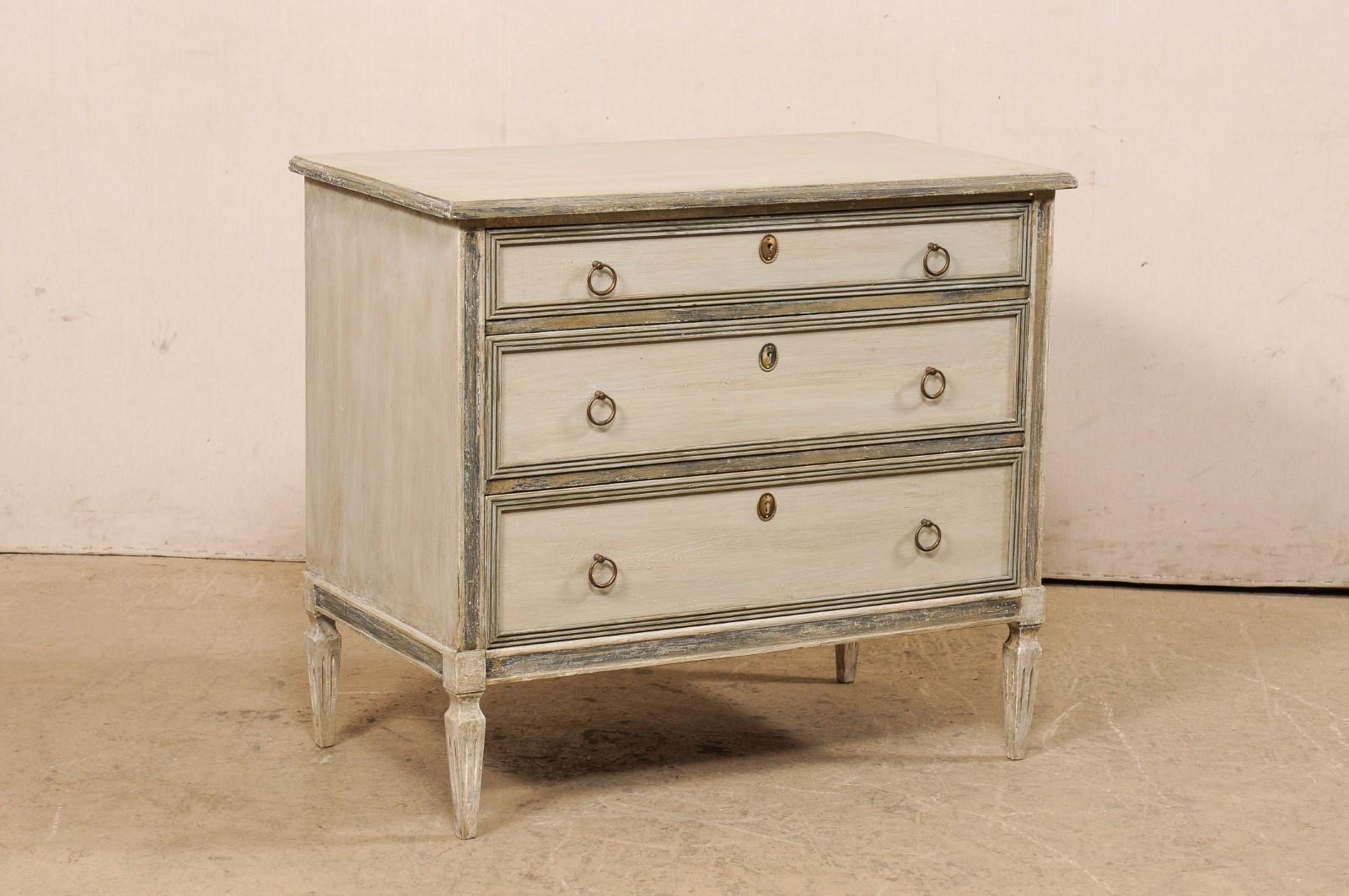 A Swedish Gustavian-style painted wood chest from the Mid-20th Century. This mid-century chest from Sweden, designed in typical Gustavian style, features a simple, clean design with slightly overhanging top over case which houses three graduated