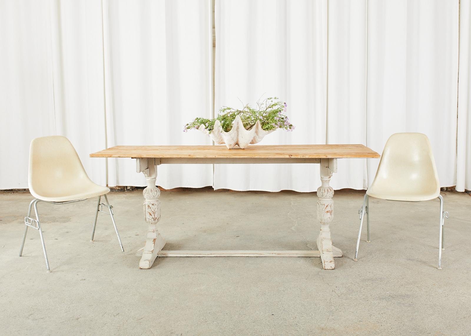 Charming late 19th century Swedish pine farmhouse table or console table. Constructed from pine having a two-board plank top with a natural or stripped finish on the pine. The Gustavian trestle style base features a light grey painted finish having