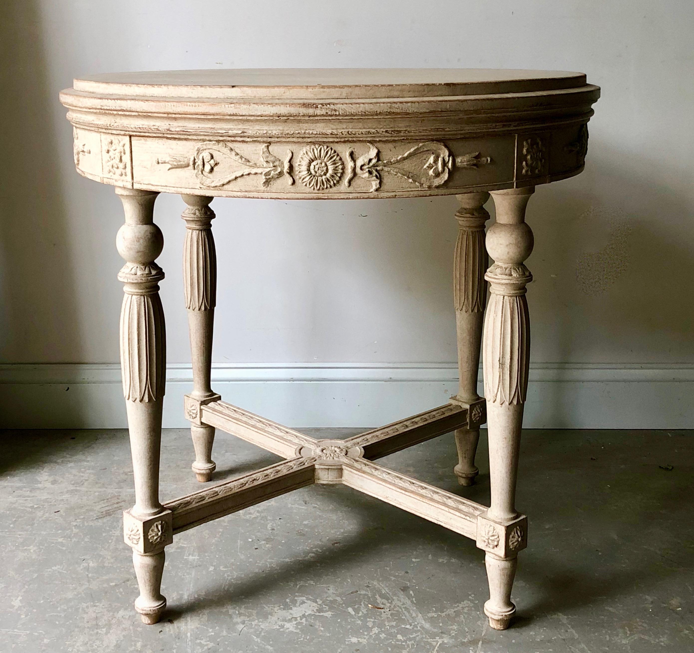 Swedish Gustavian style round table with richly carved apron, tapering carved legs and saltire stretcher with central medallion in worn cream patina. Stockholm, Sweden, circa 1880.
More than ever, we selected the best, the rarest, the unusual, the