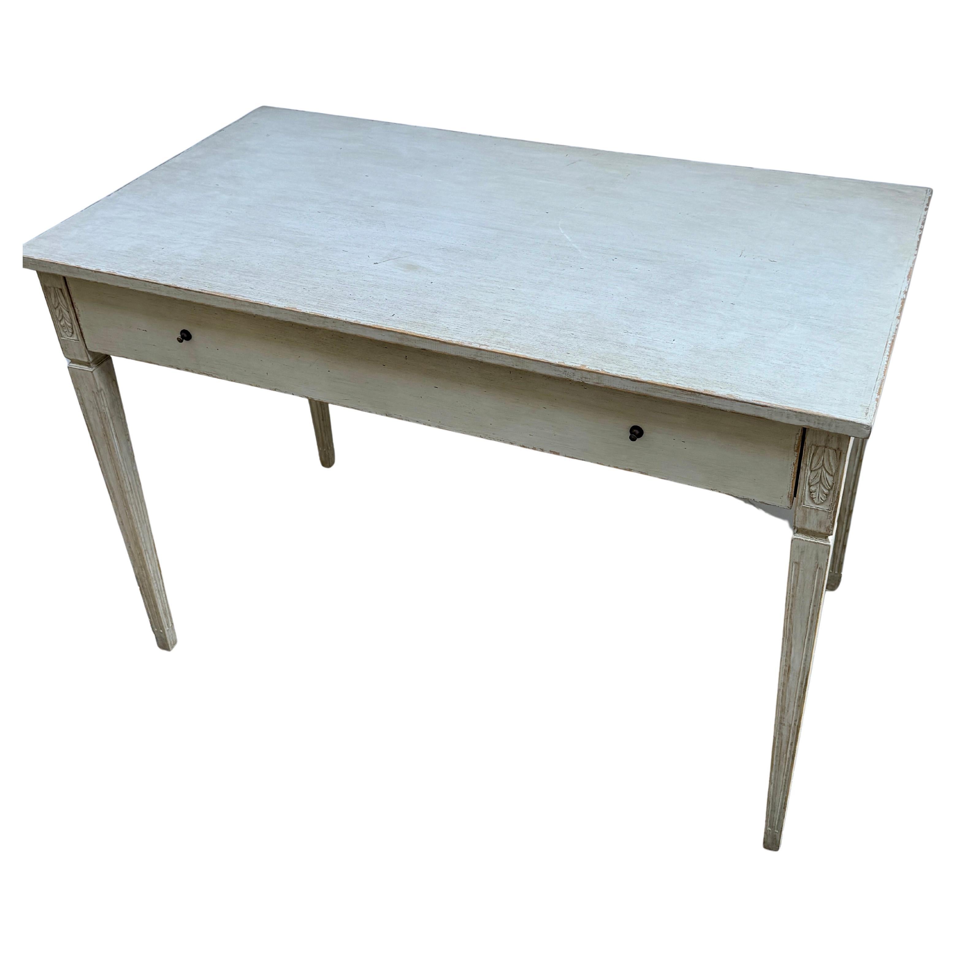 Gustavian Style Painted Writing Desk With Drawer

Classic and simple Scandinavian style writing desk. Hand carved and hand painted. Drawer knobs are bronze patinated. Wonderful piece for an office, library or sitting room. 