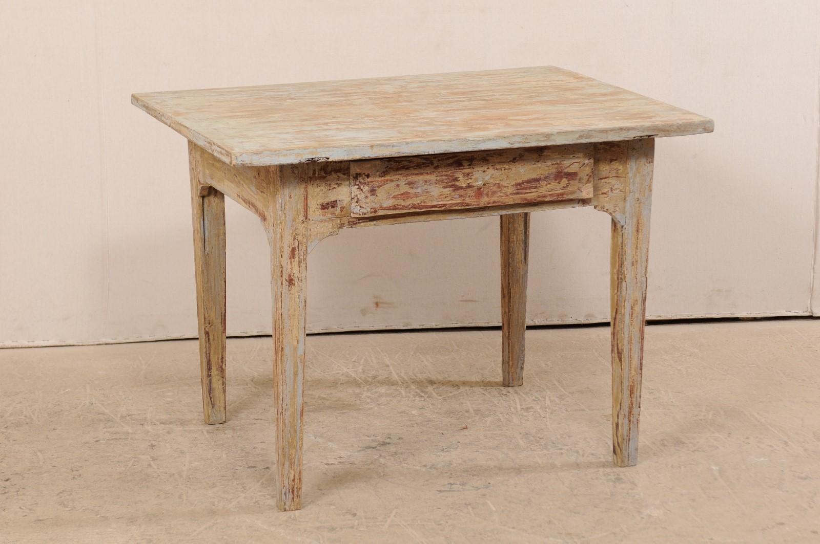 A Swedish Gustavian occasional table with single drawer from the 19th century. This antique table from Sweden is designed with simple, clean lines. It has an overhung top, resting above a plain apron with single drawer, and is raised upon four