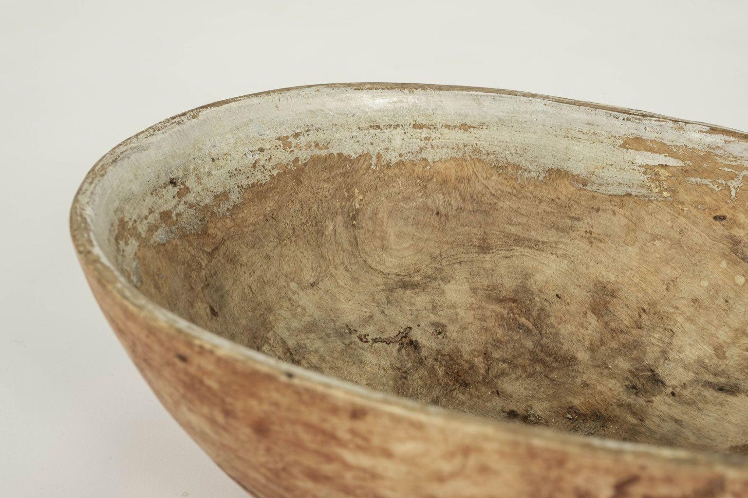 Swedish hand-carved root bowl in faded red paint, dating to 19th century. Original or early paint remnants. Marks on bottom.