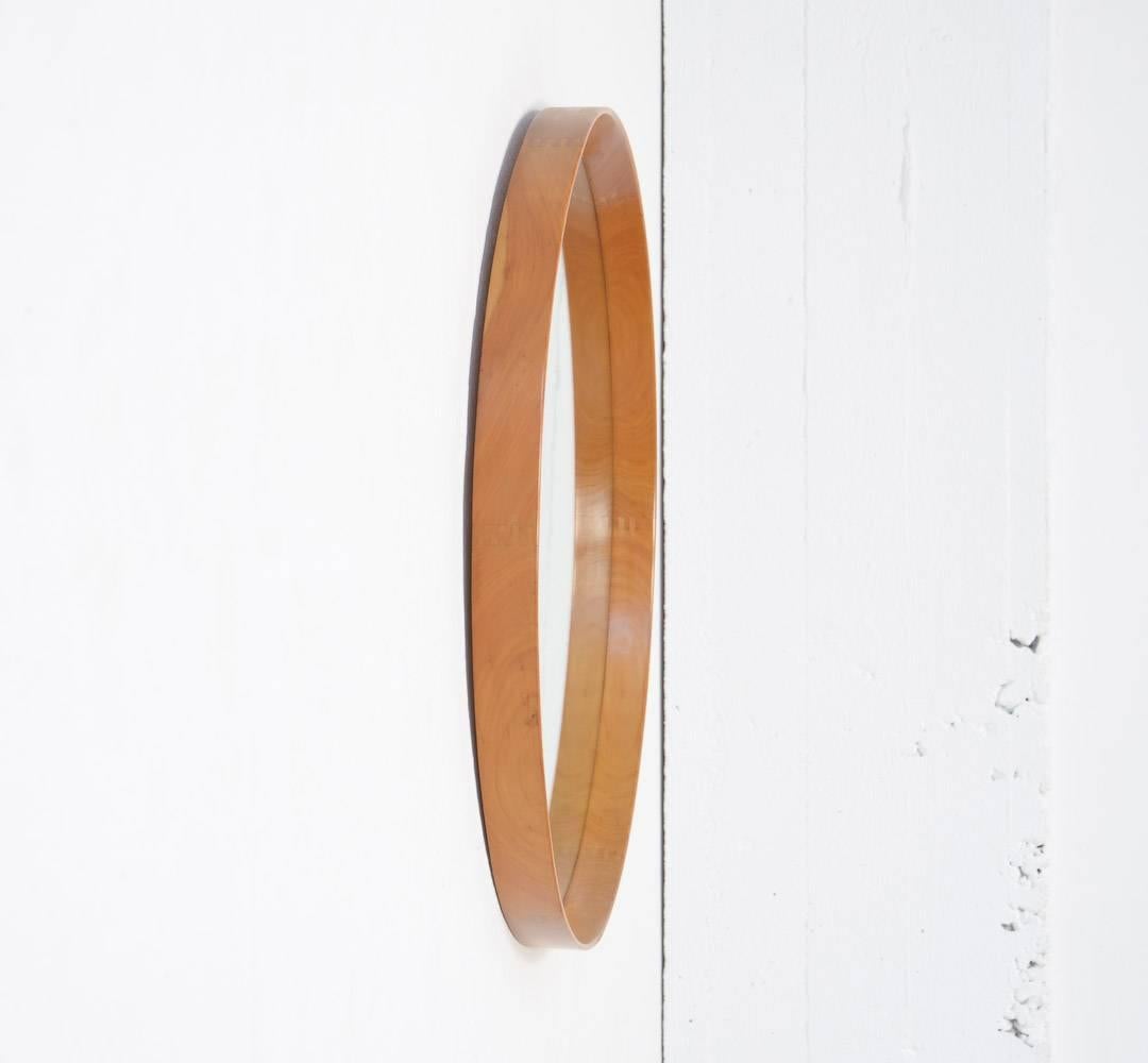 This Swedish hanging mirror is designed by Uno and Osten Kristiansson for Luxus in the 1960s.
This solid teak mirror is very nice detailed and well crafted with nice wood connections in the rim.
This large mirror is in very good vintage condition