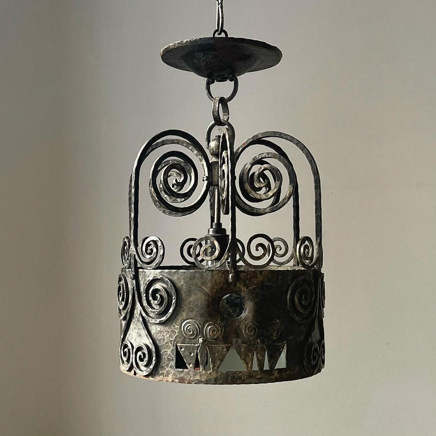 A Swedish iron lantern, first half 20th century with later glass. 

Nicely designed with geometric piercing and shaping and a grey to brown tone to the bare metal finish. Good overall condition, with lots of interesting patina from age, wear,
