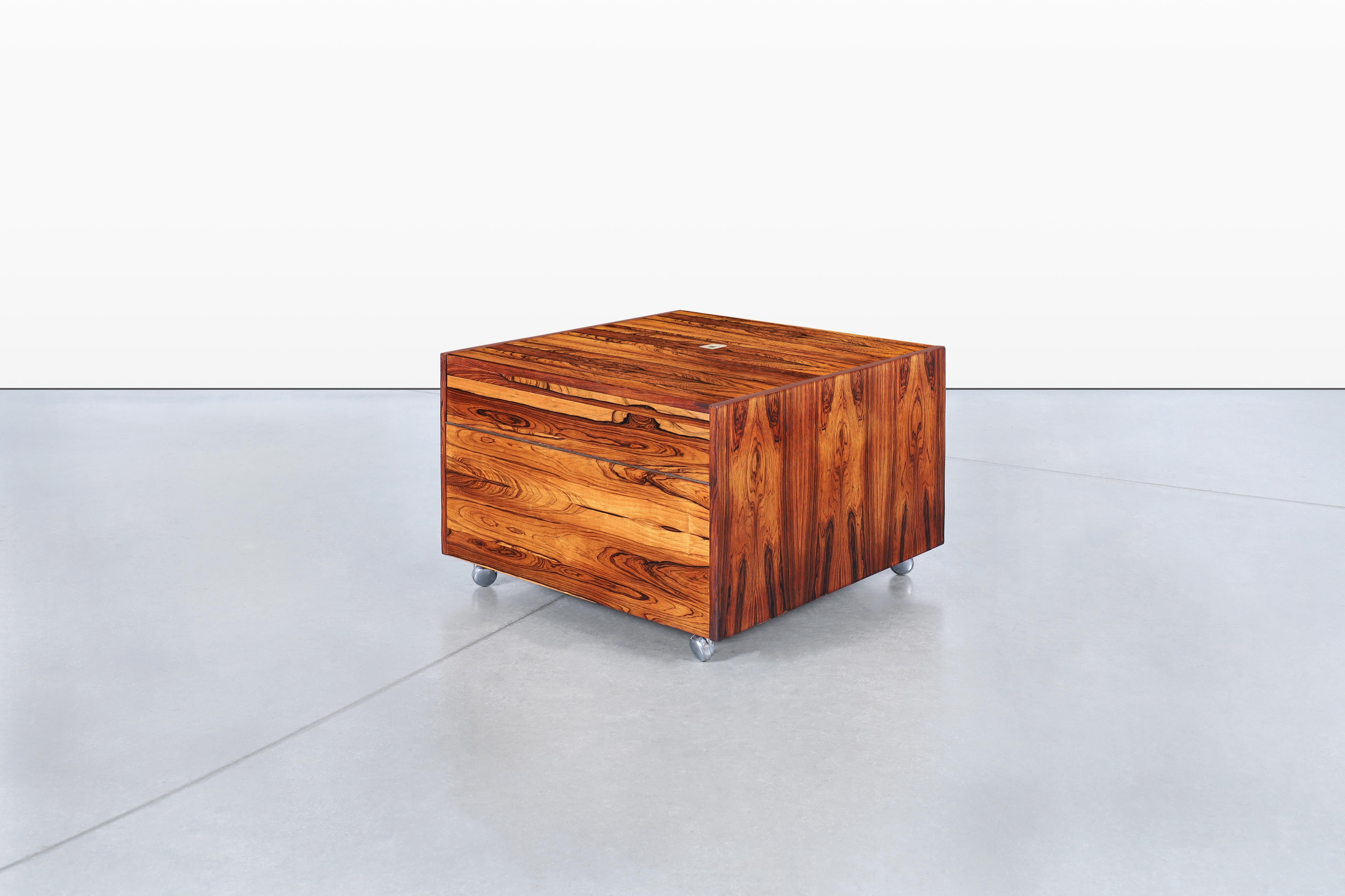 Discover the charm of this mid-century bar cabinet, designed by Gillis Lundgren and crafted in Sweden by Ikea in the 1960s. This versatile piece is made from stunning Jacaranda wood, which has been expertly restored to enhance its rich grain and