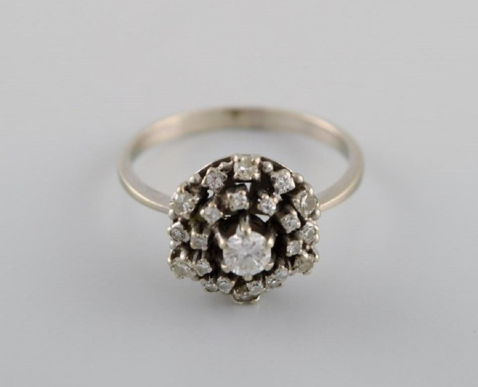 Swedish jeweler. Ring in 18 carat white gold adorned with a brilliant and 22 diamonds. Late 20th century.
In excellent condition.
Diameter: 18 mm.
US size: 7.5.
Carat: 0.50.
Weight: 3.2 grams.
Stamped.
In most cases, we can change the size for a fee