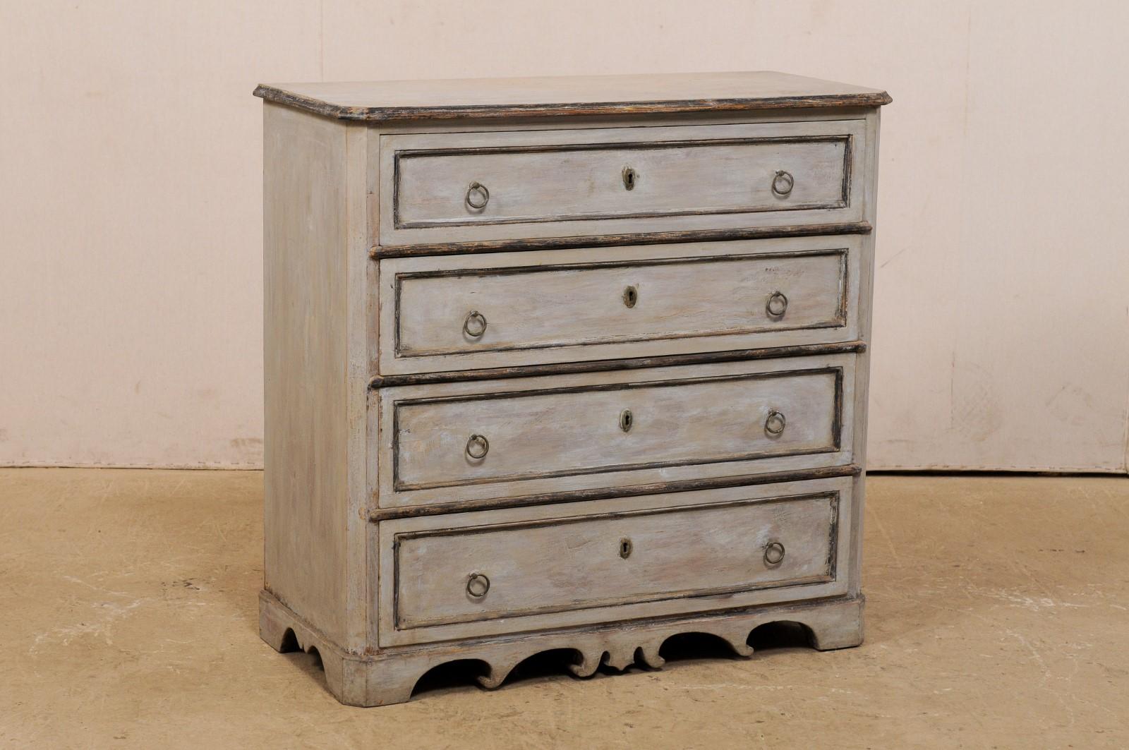 A Swedish painted wood chest of four drawers from the mid-19th century. This antique Karl Johan chest, circa 1850, features a slightly overhanging top with rounded front corners, with a case beneath which houses four dovetailed drawers, each adorn