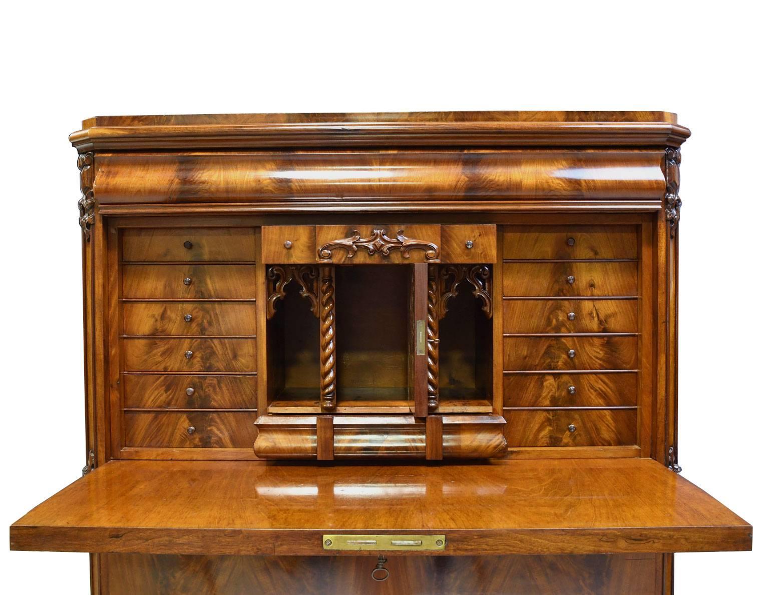 A very handsome chest in West Indies mahogany with shaped drawer above fall-front that opens to a secretary, over three large storage drawers. Interior desk offers a multitude of small drawers surrounding a closed, center compartment flanked by