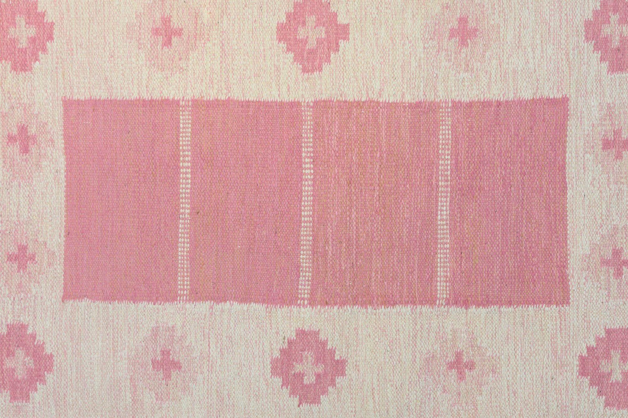 Mid-Century Swedish kilim in muted tones of pinks and beige signed GG. Sweden circa 1960. All our carpets undergo a professional cleaning process. However, due to their age and previous life, some may exhibit minor signs of wear consistent with