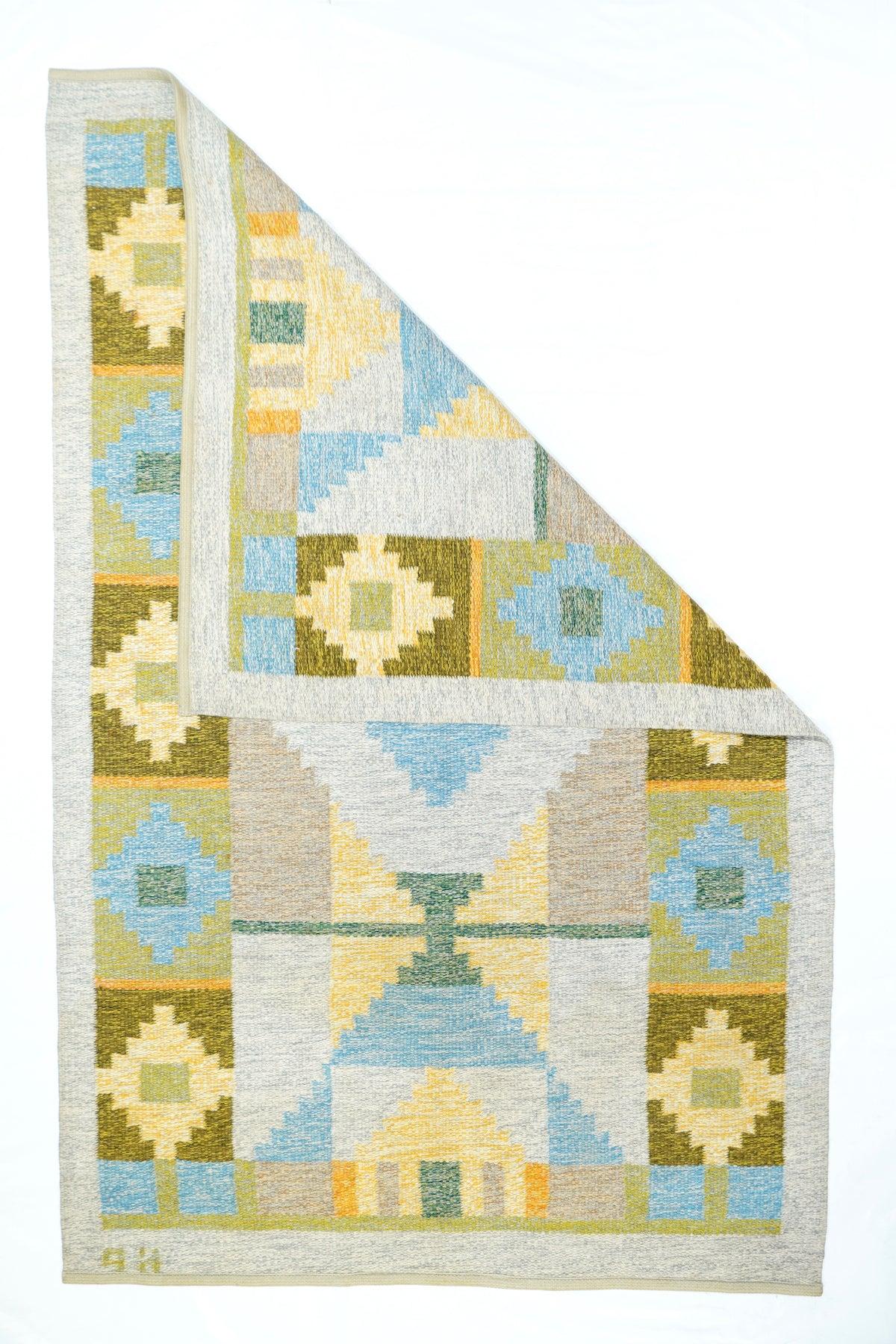 Swedish Kilim Rug 4'3'' x 6'7''. Looks Navajo, but with a wider palette and looser, shared warp construction. Rust and tangerine panels alternate along the sides, enclosing stepped diamonds in straw and pale blue. Central section with stepped