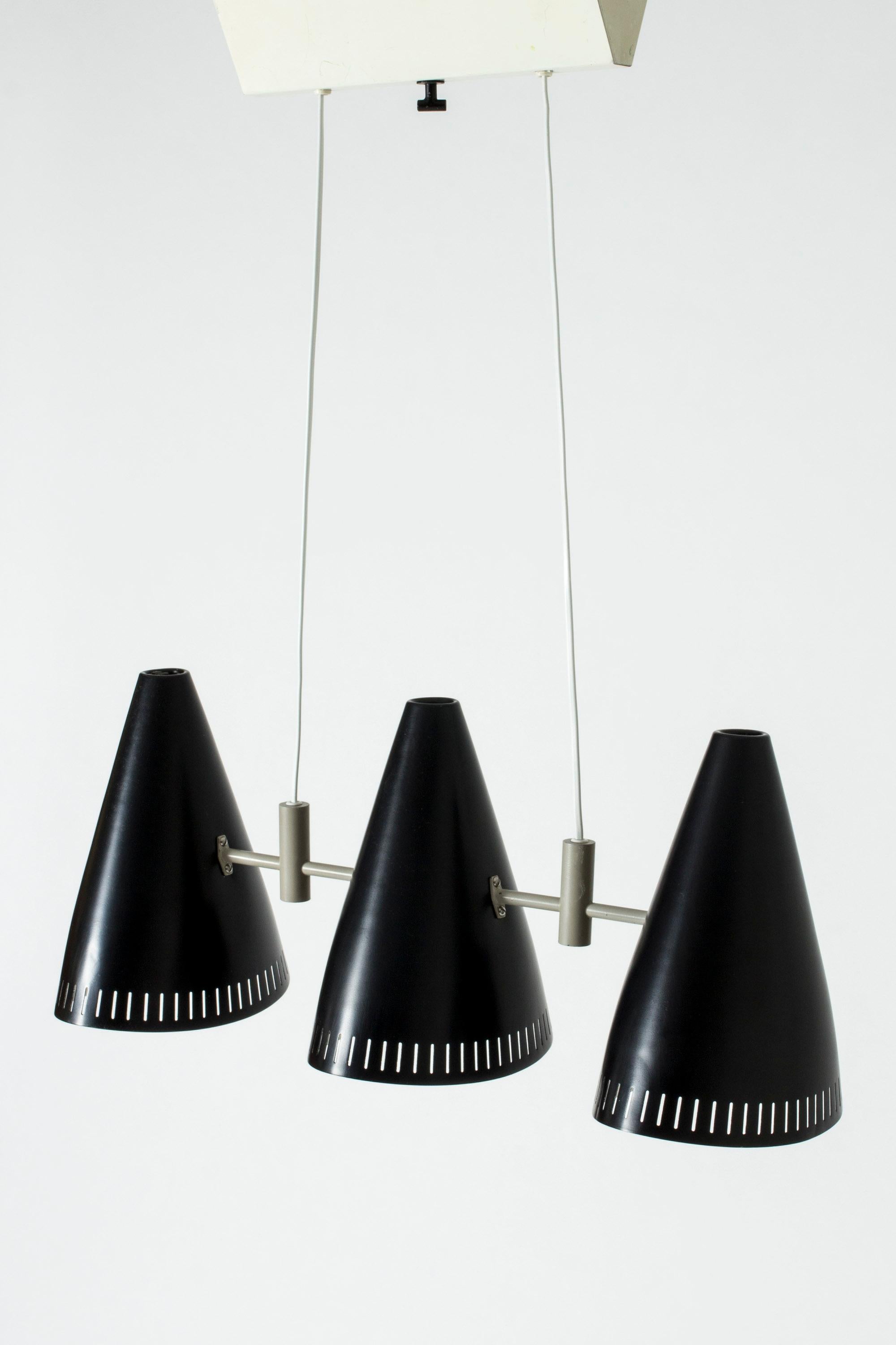 Very cool ceiling lamp by Eje Ahlgren, with three black lacquered shades. Sleek graphic look with light grey lacquered details and a long, boxy ceiling cup.
