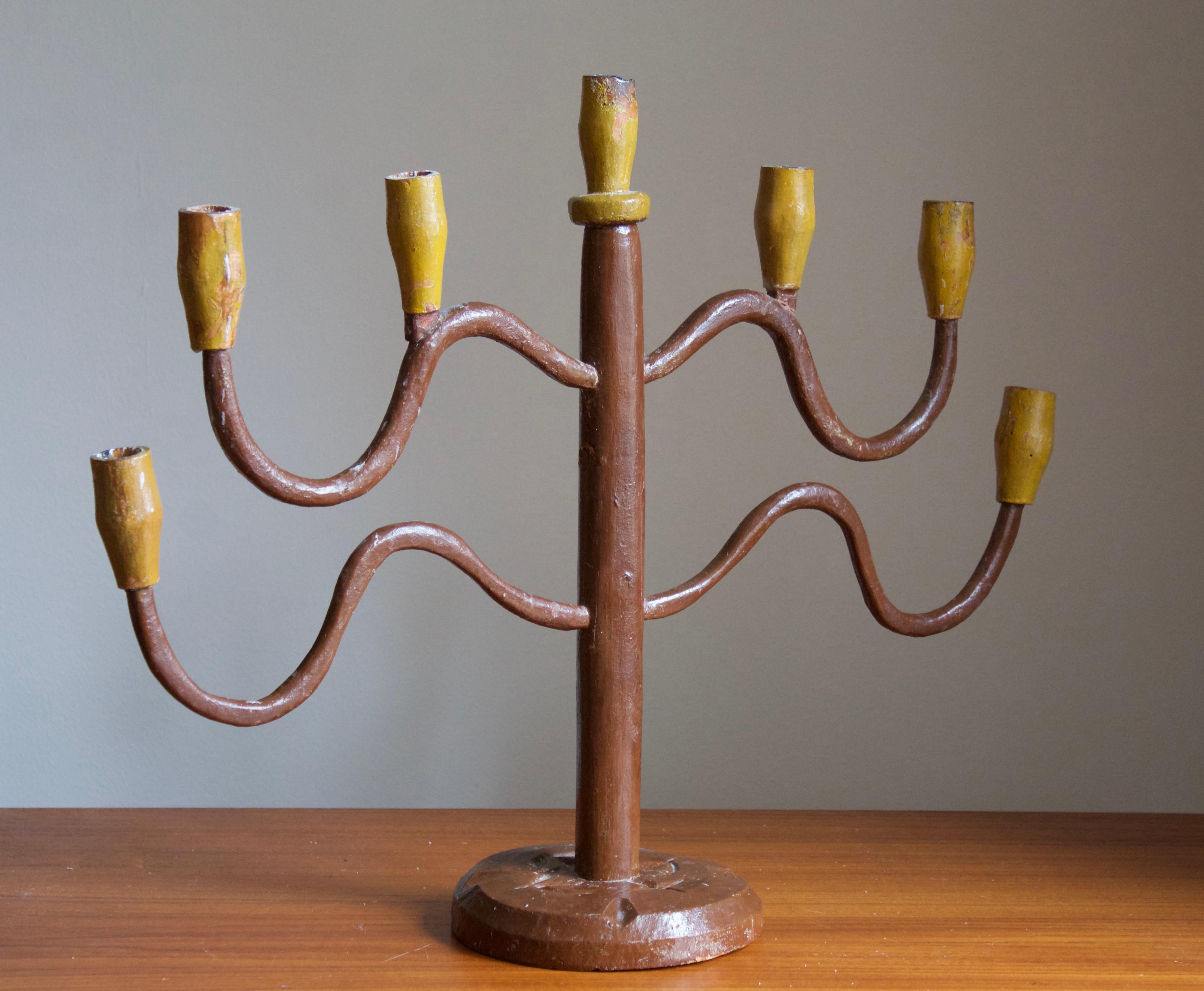 A large candelabra. In painted wood. Underside with a scribbled note of the candelabra passing through inheritance in 1946.