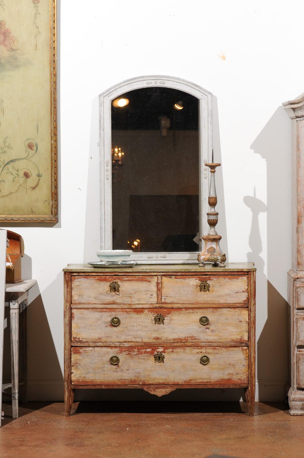A Swedish Gustavian period four-drawer chest from the late 18th century, with nicely distressed appearance. Created in Sweden during the last quarter of the 18th century, this chest features a rectangular marbleized top with canted corners in the