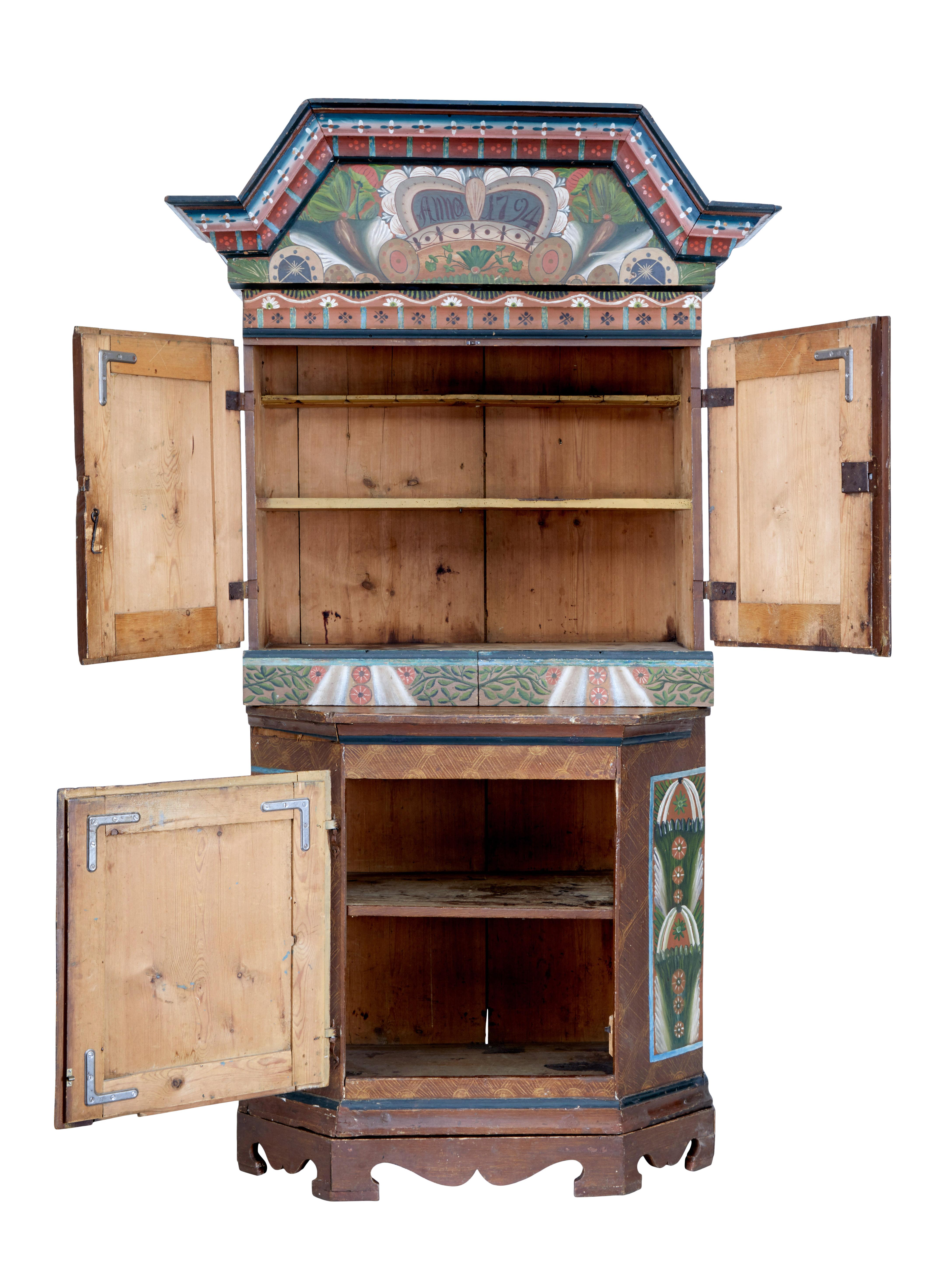 Swedish late 18th century hand painted folk art cupboard circa 1794.

Good quality traditional painted scandinavian cupboard, comprising of a removable cornice and a main body which stands on a seperate base.

Hand painted in brown, orange, blue