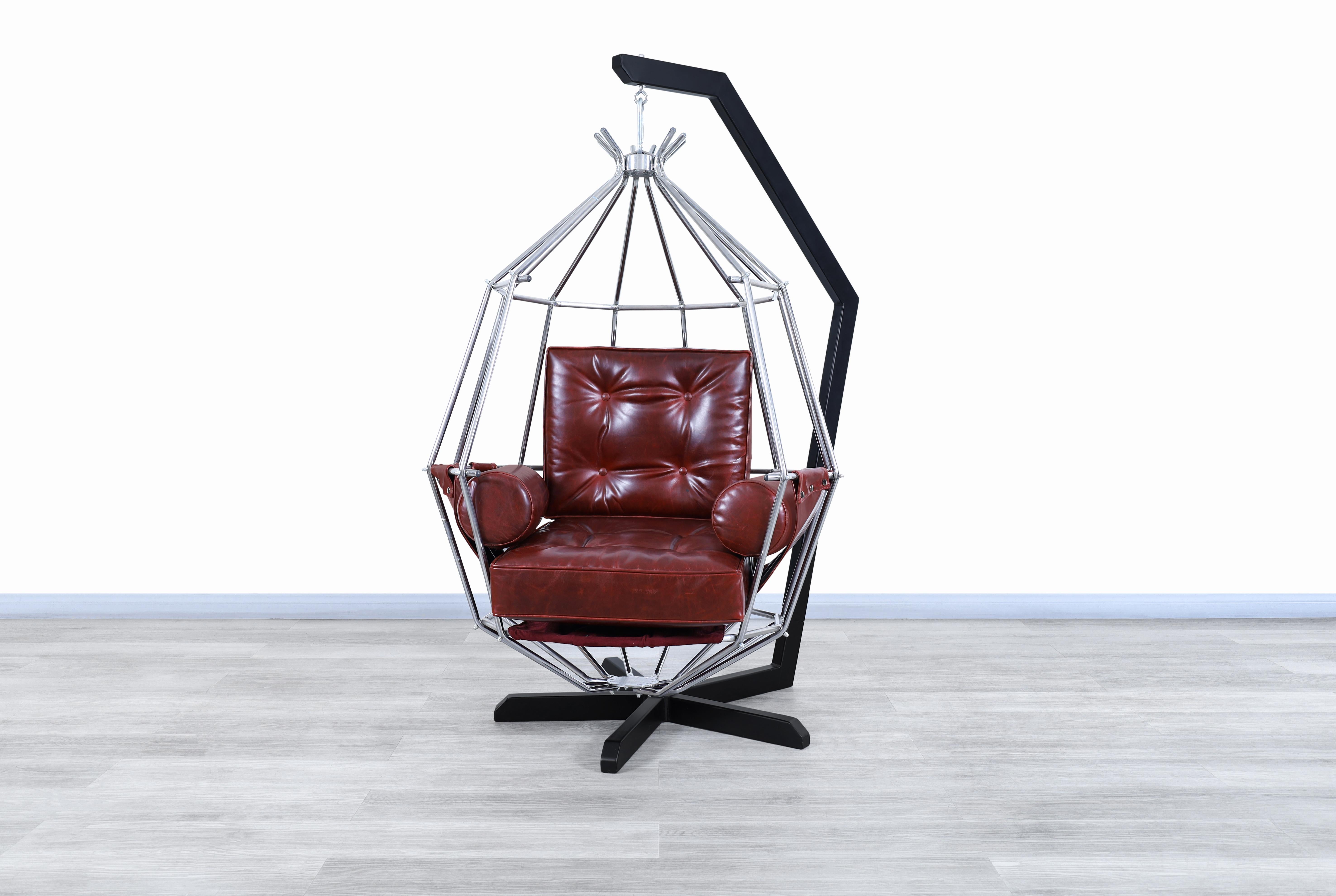 Stunning vintage leather “Perrot Cage” swing chair designed by Ib Arberg in Sweden, circa 1970s. This chair has an extravagant design that mixes different materials in a significant way, resulting in an elegant and captivating piece of furniture at