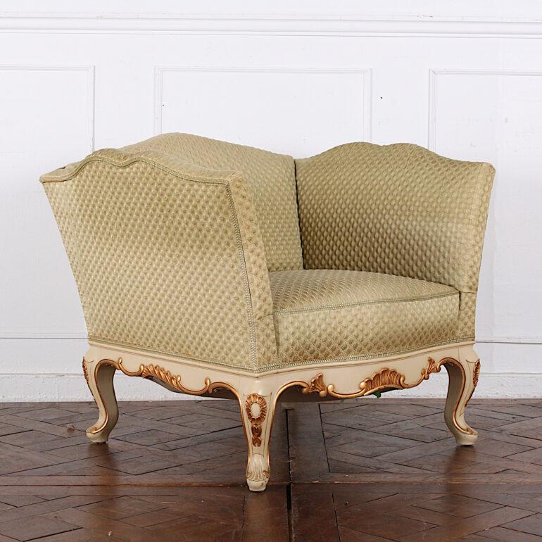 An mid-20th century Swedish Louis XV style armchair with a hand-carved and painted skirt and legs with gilt accents.

 