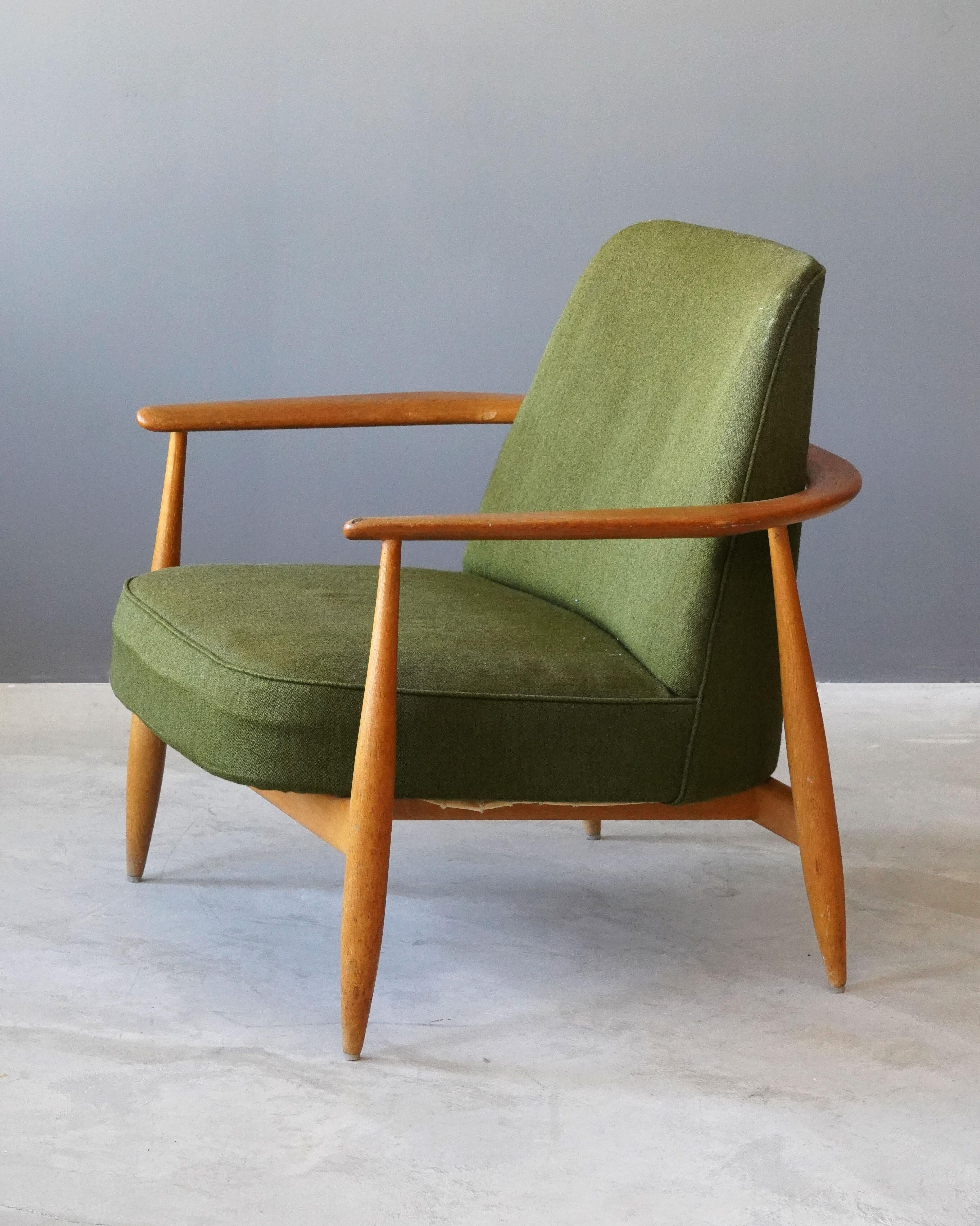 A lounge chair in finely turned oak. Designed and produced in Sweden, 1950s. Vintage fabric.

Other designers working in similar style include Ib Kofod-Larsen, Arnold Madsen, Finn Juhl, and Arne Jacobsen.